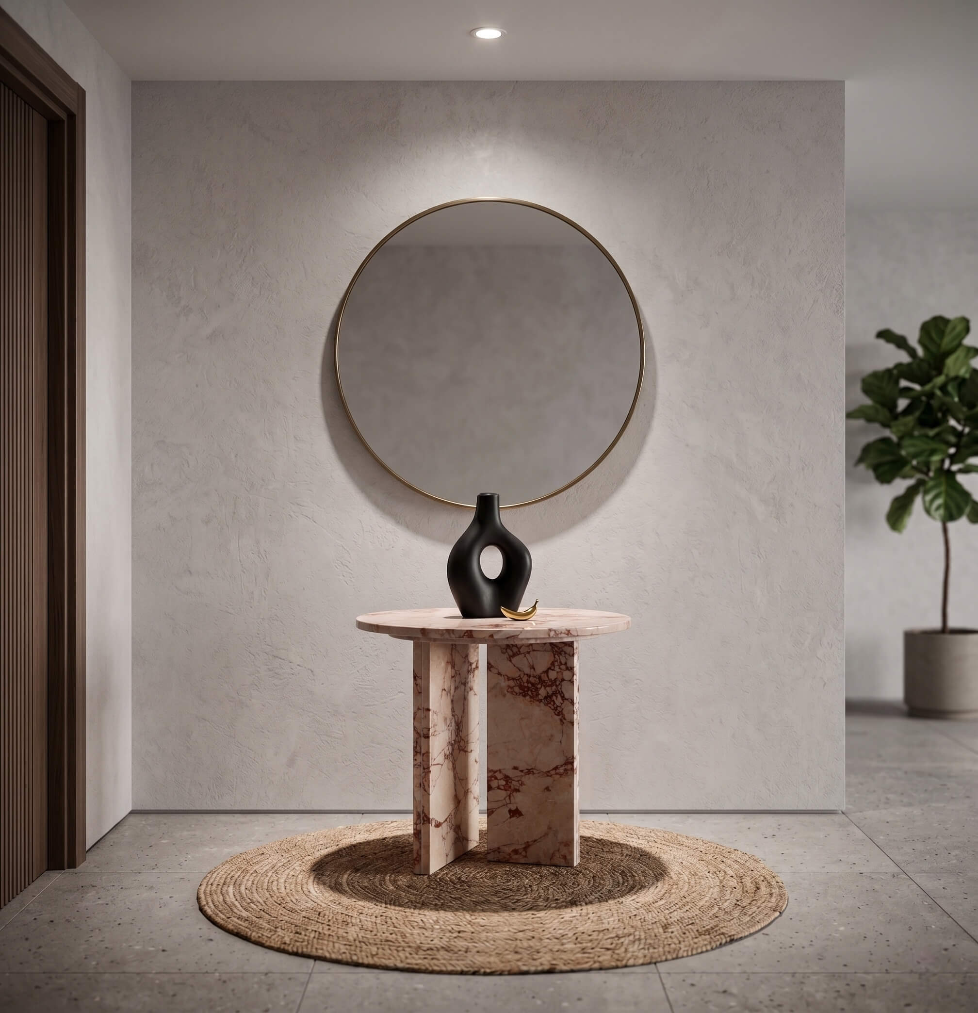 Diamond Pink marble side table used as a foyer statement piece beneath a large gold-frame circular mirror — round jute rug, matte black ceramic vase, gold banana decorative object, limewash plaster wall, contemporary minimalist entryway with fiddle leaf fig.