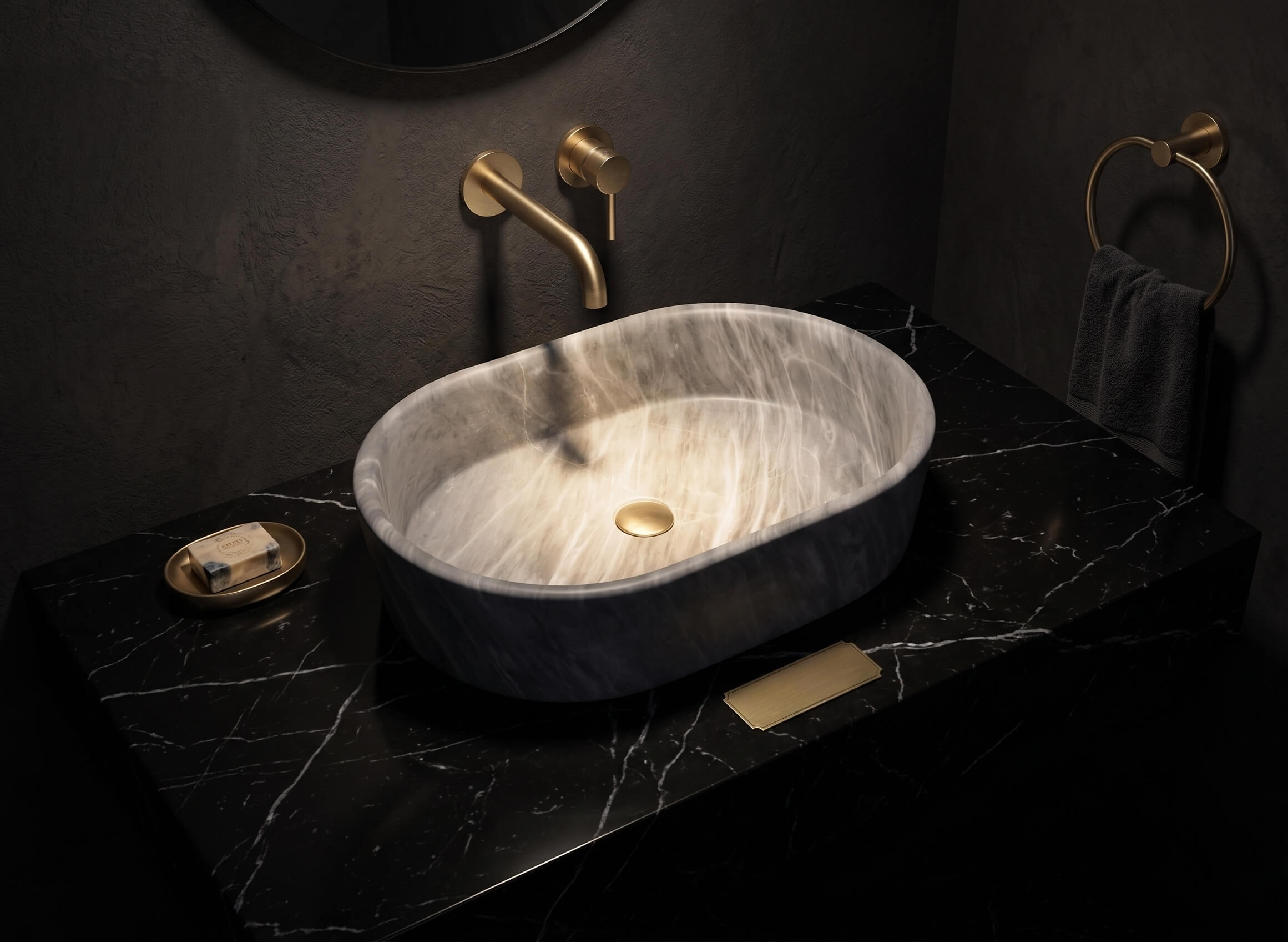 Carrara gray marble vessel sink on black Nero Marquina counter with brushed brass wall faucet in dark plaster bathroom.