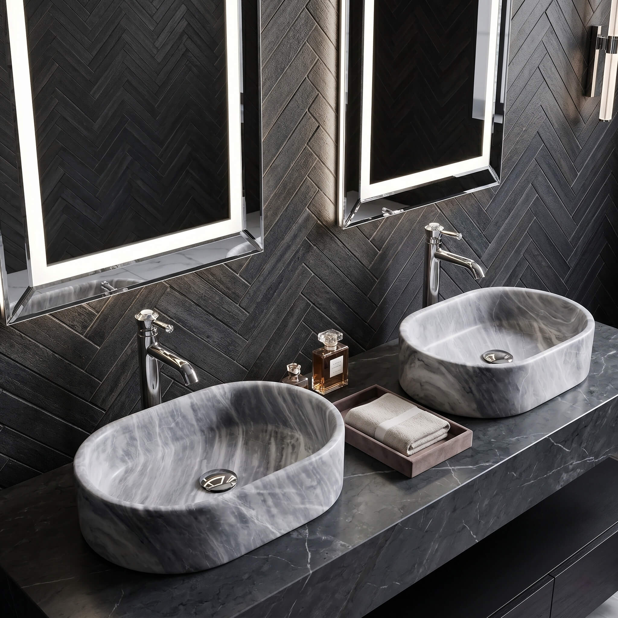 Two Carrara gray marble vessel sinks on dark counter against herringbone tile wall with chrome faucets and LED mirrors.