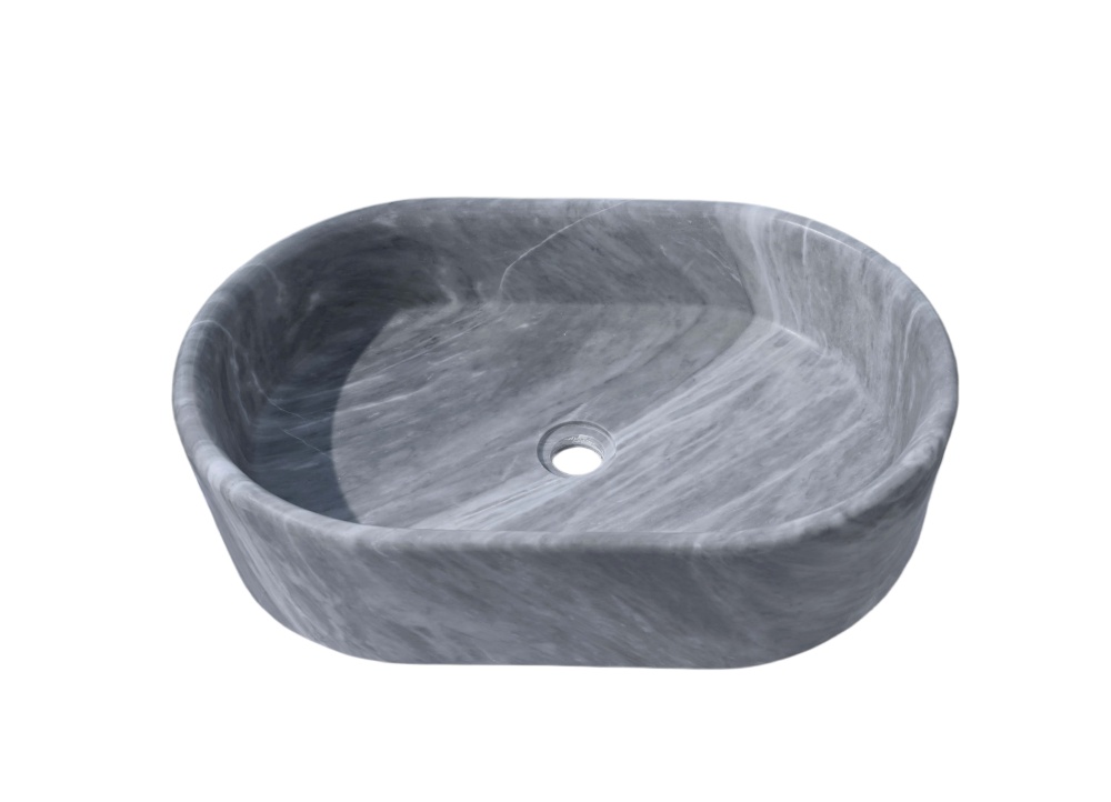 Oval Carrara gray natural marble vessel sink with honed finish, viewed from 45-degree front angle showing veining detail and center drain hole.