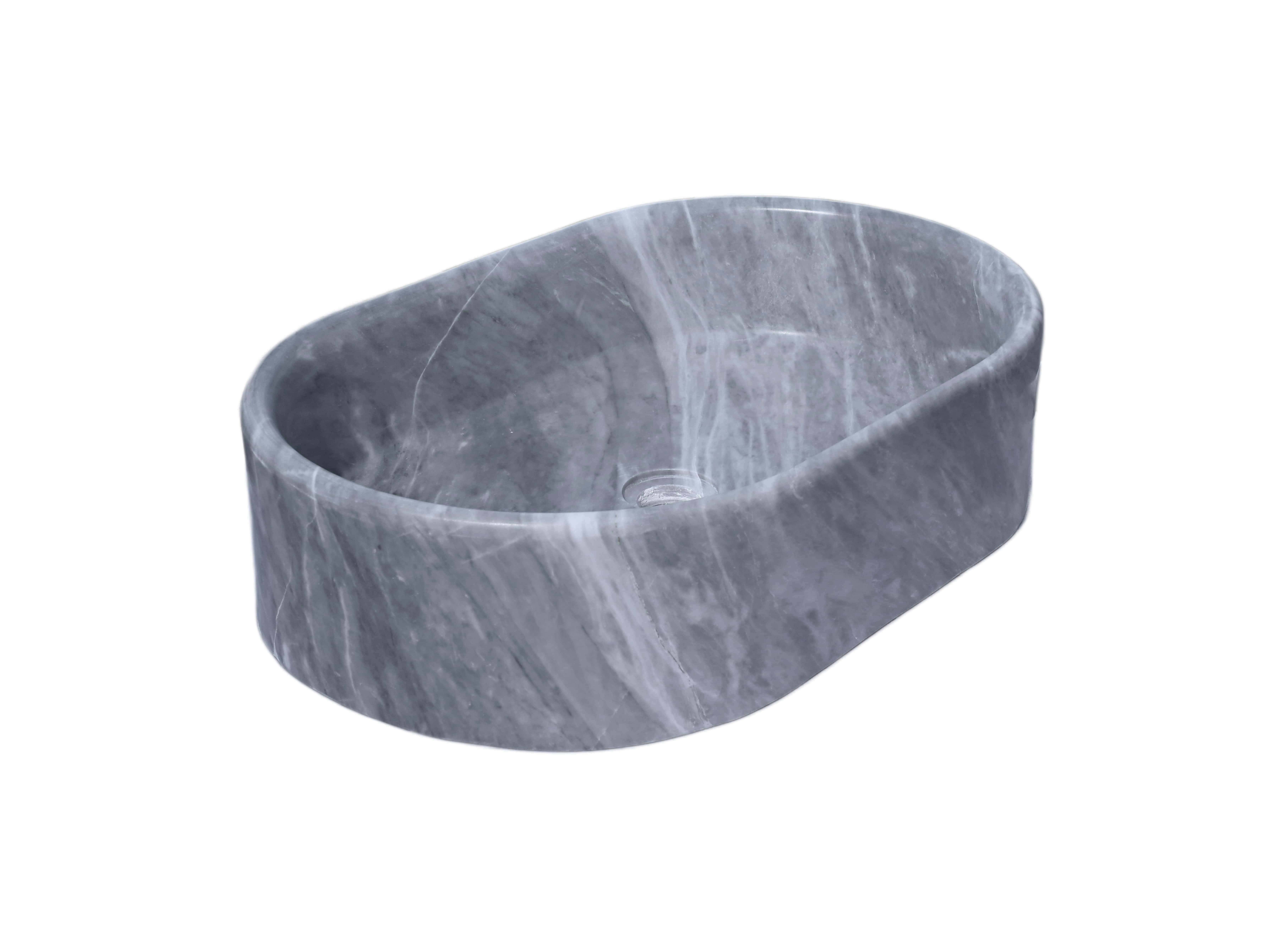 Oval Carrara gray marble vessel sink with hand-honed finish, low-angle side profile showing 150mm bowl height and continuous block-carved silhouette.