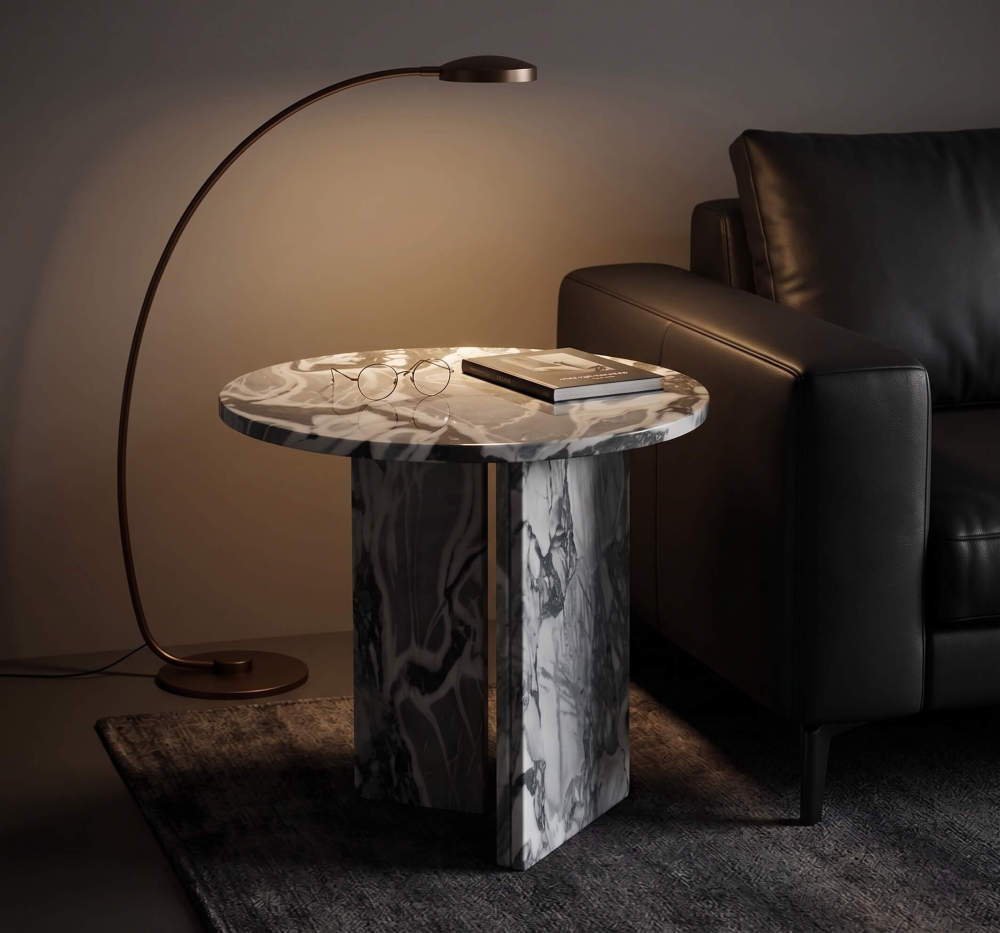 Cloudy blue marble side table beside black leather sofa, arch floor lamp casting warm light, hardcover book and round reading glasses on top.