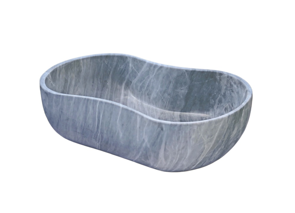 45-degree angle view of block-carved Carrara gray marble vessel sink revealing wavy rim contour, basin interior and side-wall veining continuity.