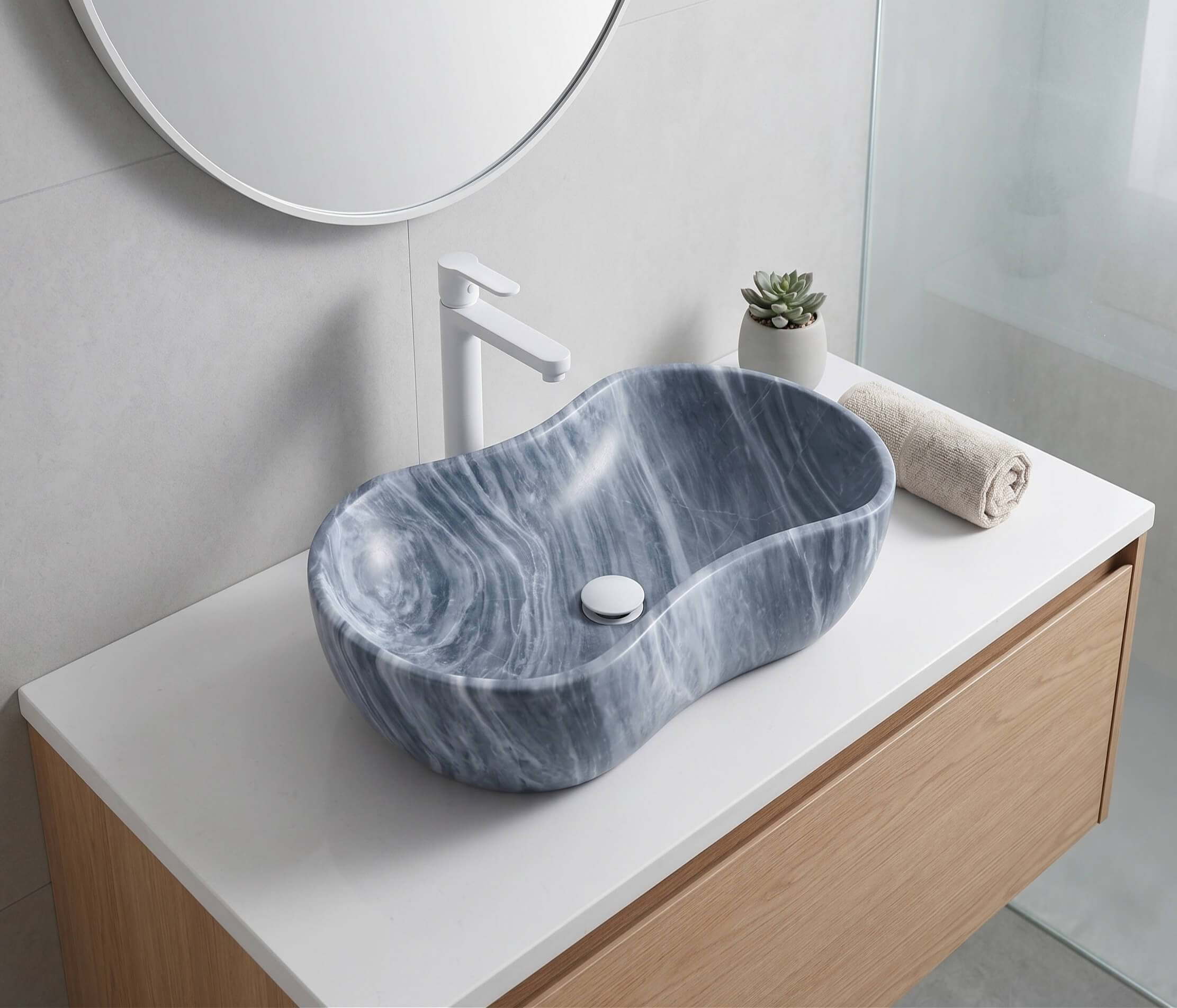 Carrara gray marble vessel sink on white quartz counter with matte white faucet and oak vanity in a light airy Nordic contemporary bathroom.