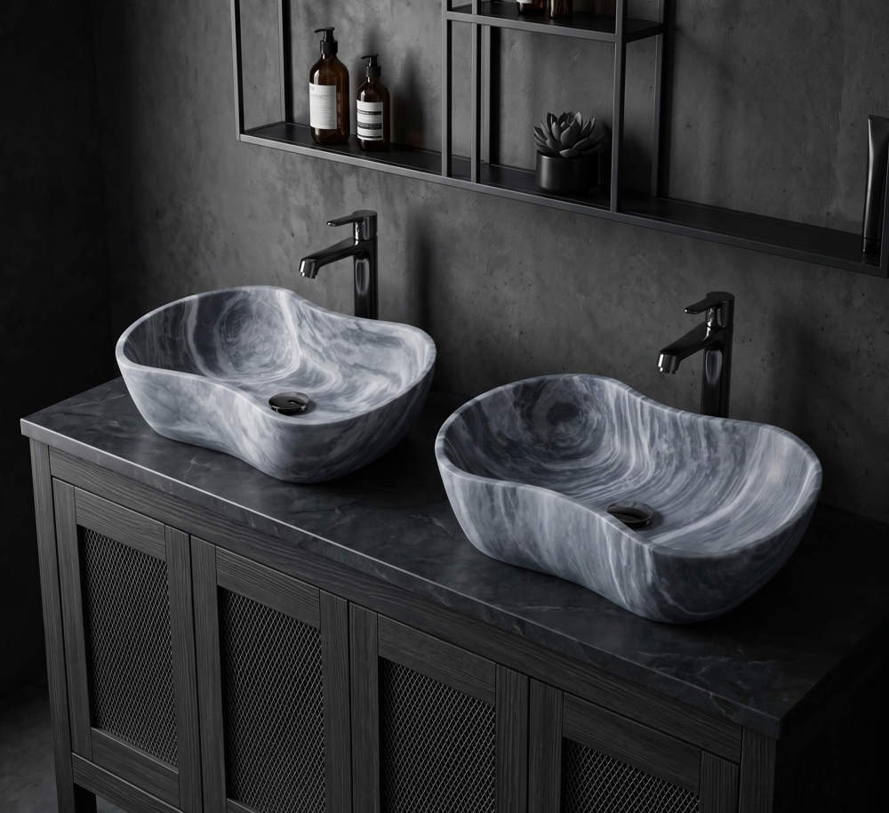 Pair of Carrara gray marble vessel sinks on dark stone counter with matte black faucets and concrete walls in an industrial dark loft bathroom.