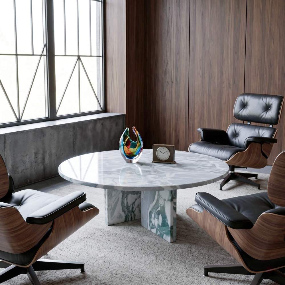 Cloudy blue marble coffee table styled with Eames-style walnut lounge chairs, Murano glass vase, and concrete-wood mid-century interior.