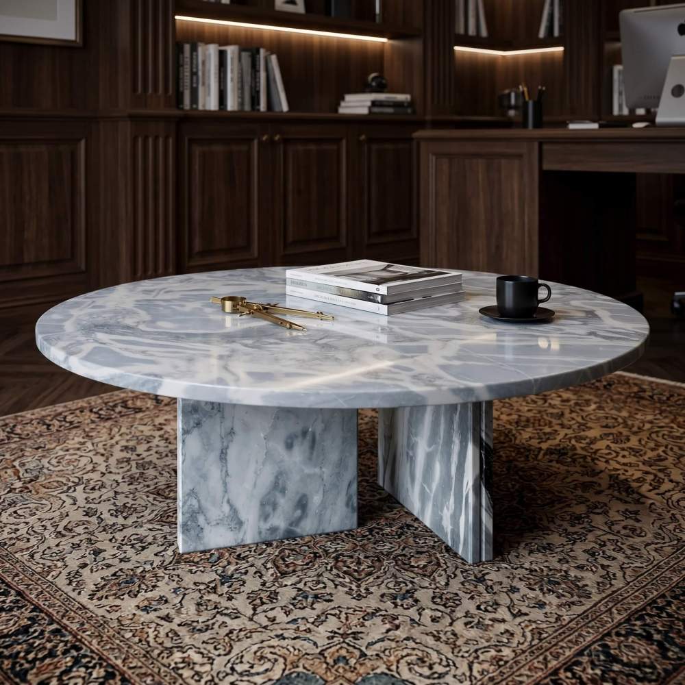 Cloudy blue marble coffee table in walnut-paneled study with brass drafting compass, design books, espresso cup, and Persian rug.