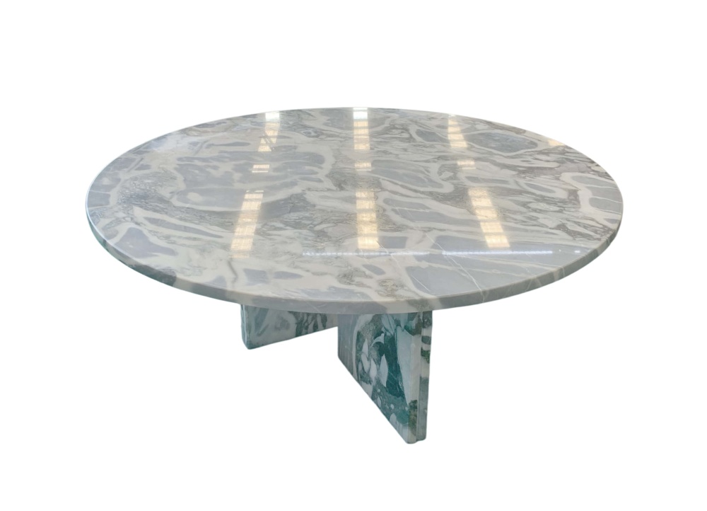 Round cloudy blue marble coffee table, polished finish, dramatic white veining with deep gray mineral patches across the tabletop.