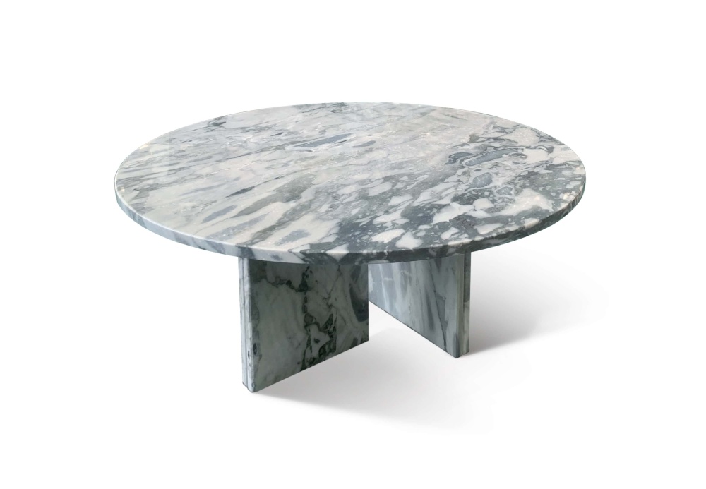 Polished cloudy blue marble coffee table top showing irregular white cloud patterns and dark green mineral clusters on natural stone.
