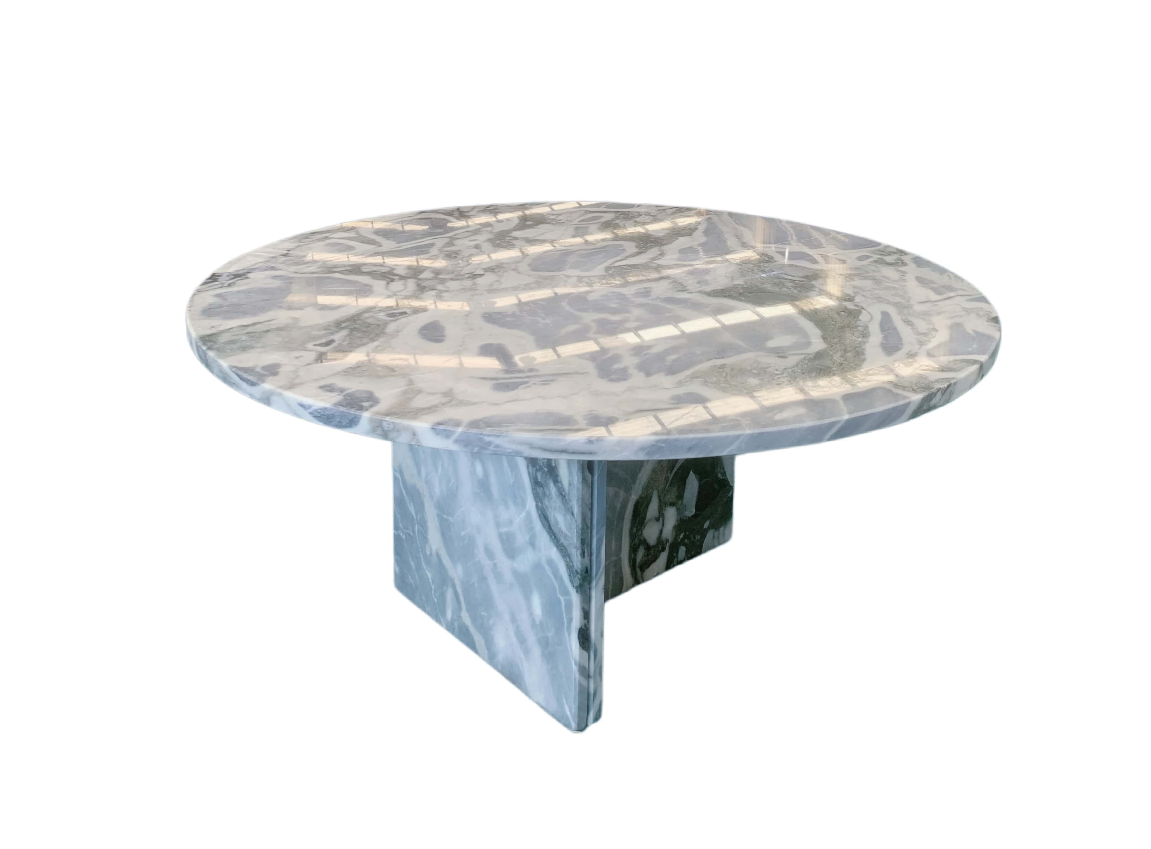 Round cloudy blue marble coffee table, polished surface displaying layered white cloud-like patches over deep blue-gray stone.