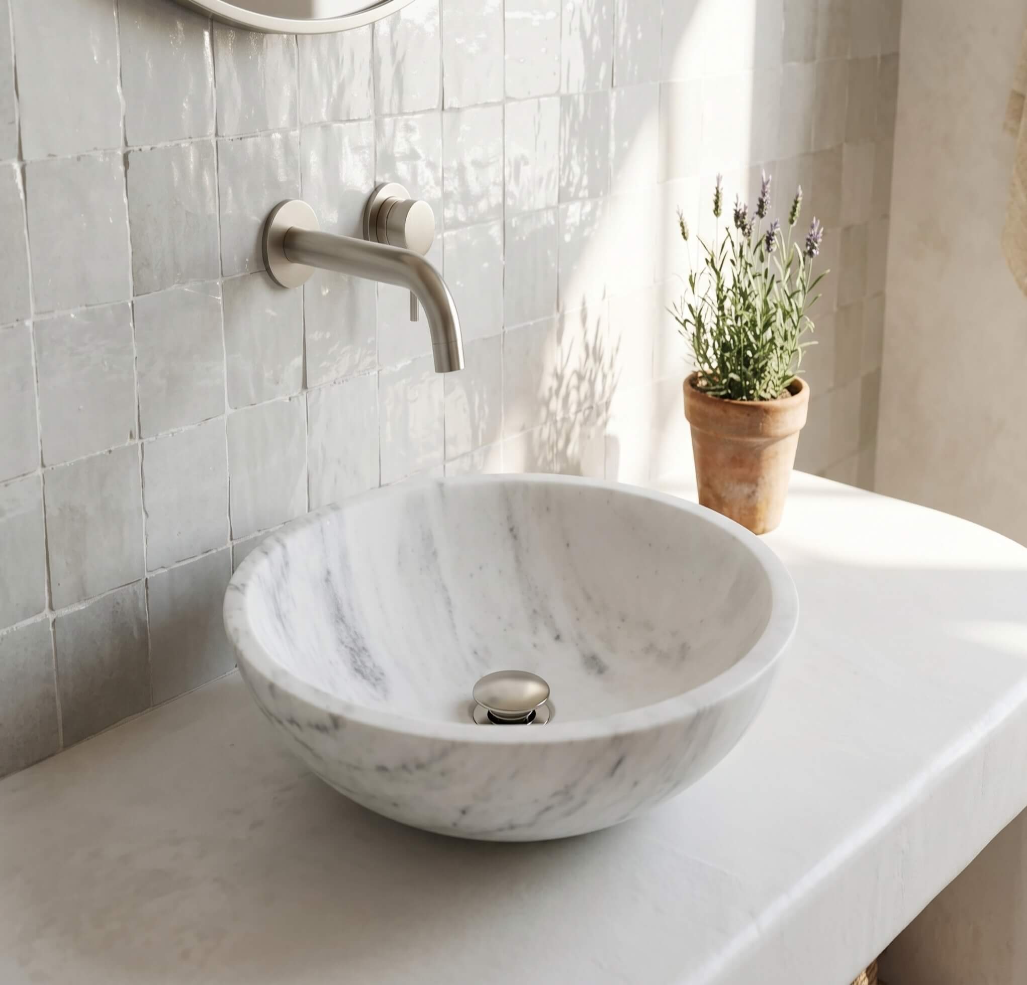 Snow Mountain white marble vessel sink on plaster counter, white zellige tile, brushed nickel faucet, Provence bath.
