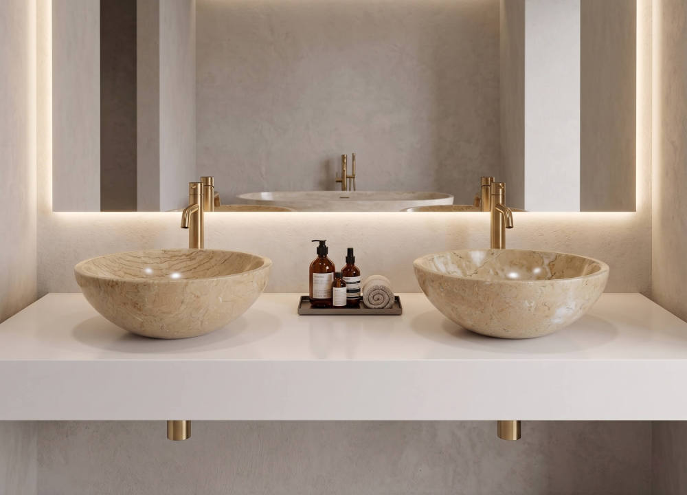 Two Hyatt Gold marble vessel sinks on white floating counter with brushed brass faucets and LED cove lighting, minimalist hotel suite.