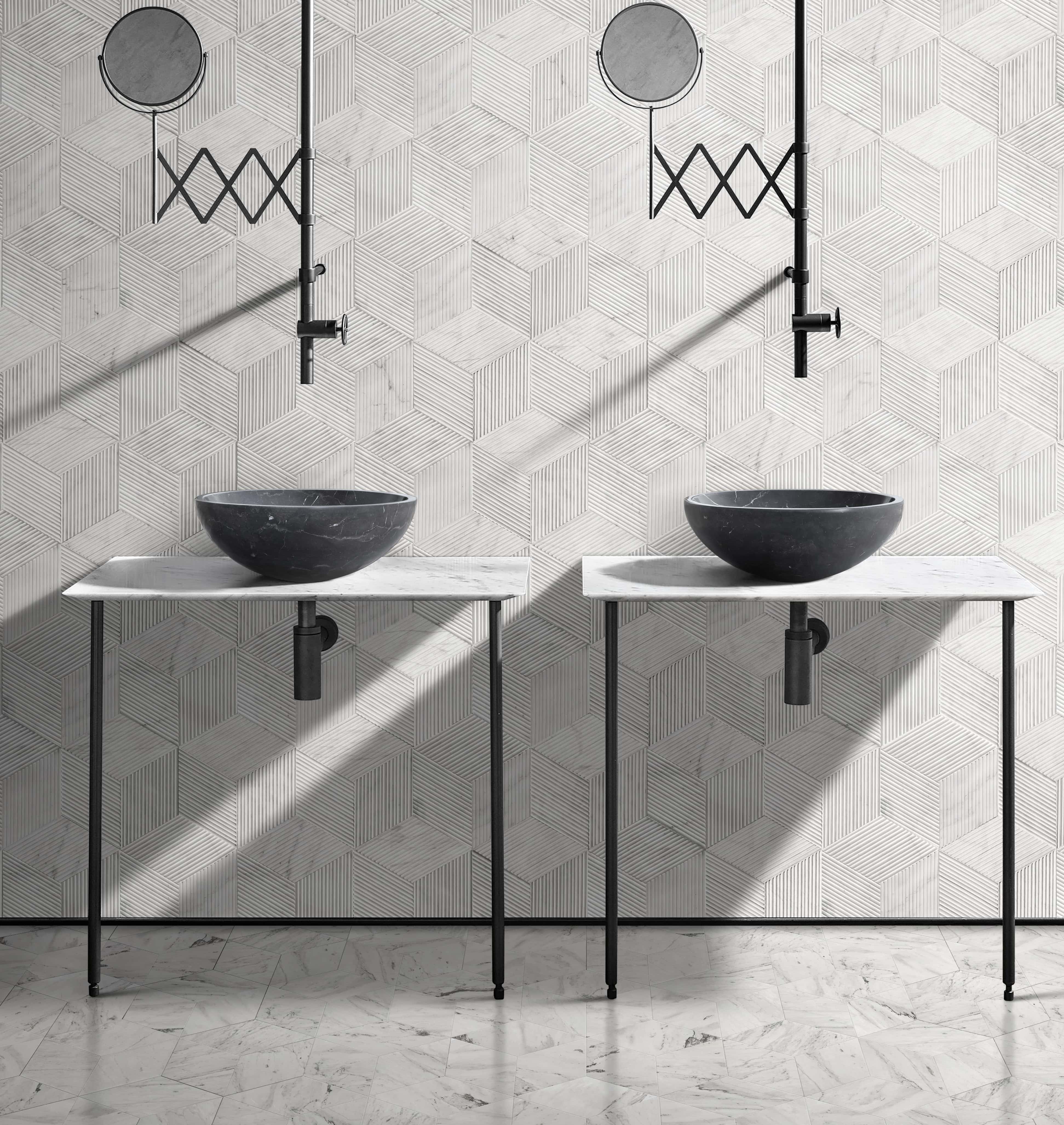 Paired black marble vessel sinks with white hexagon textured wall tile and polished floor tile in coordinated marble bathroom.
