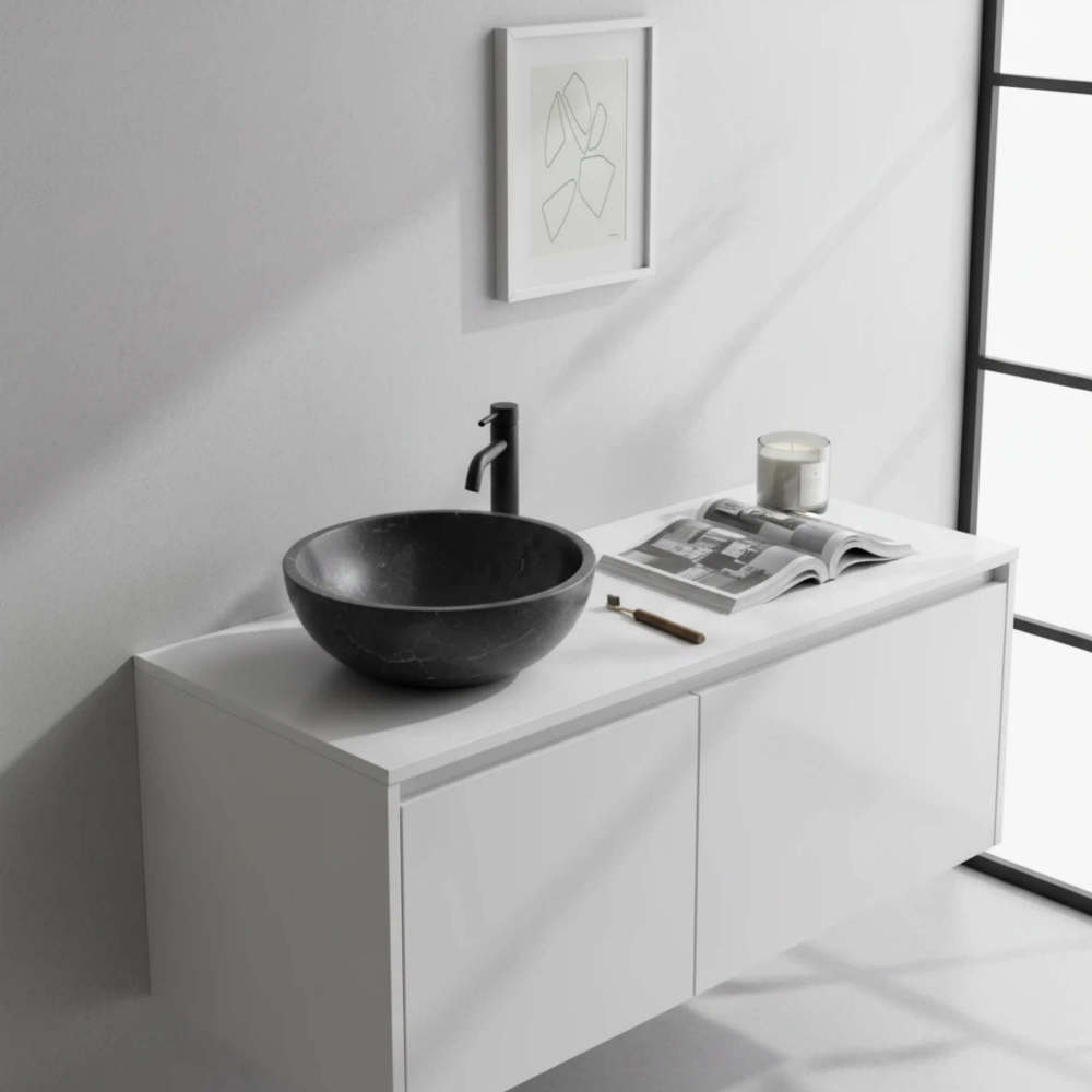 Black marble vessel sink on white floating vanity with matte black faucet, line-art print in Scandinavian minimalist bathroom.