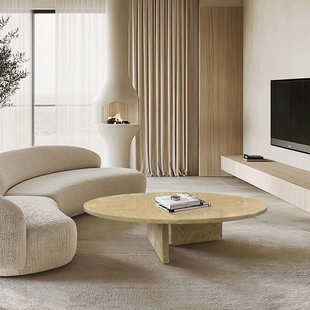 Round Hyatt Gold marble coffee table paired with curved bouclé sofa beside a modern fireplace in a Japandi-style living room.