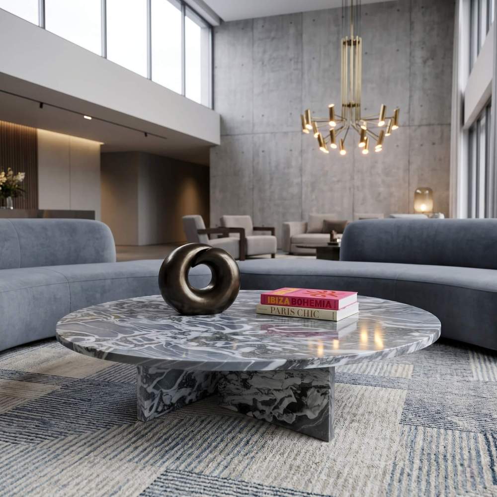 Cloudy blue marble coffee table in a double-height boutique hotel lobby with curved velvet sofas and brass chandelier.