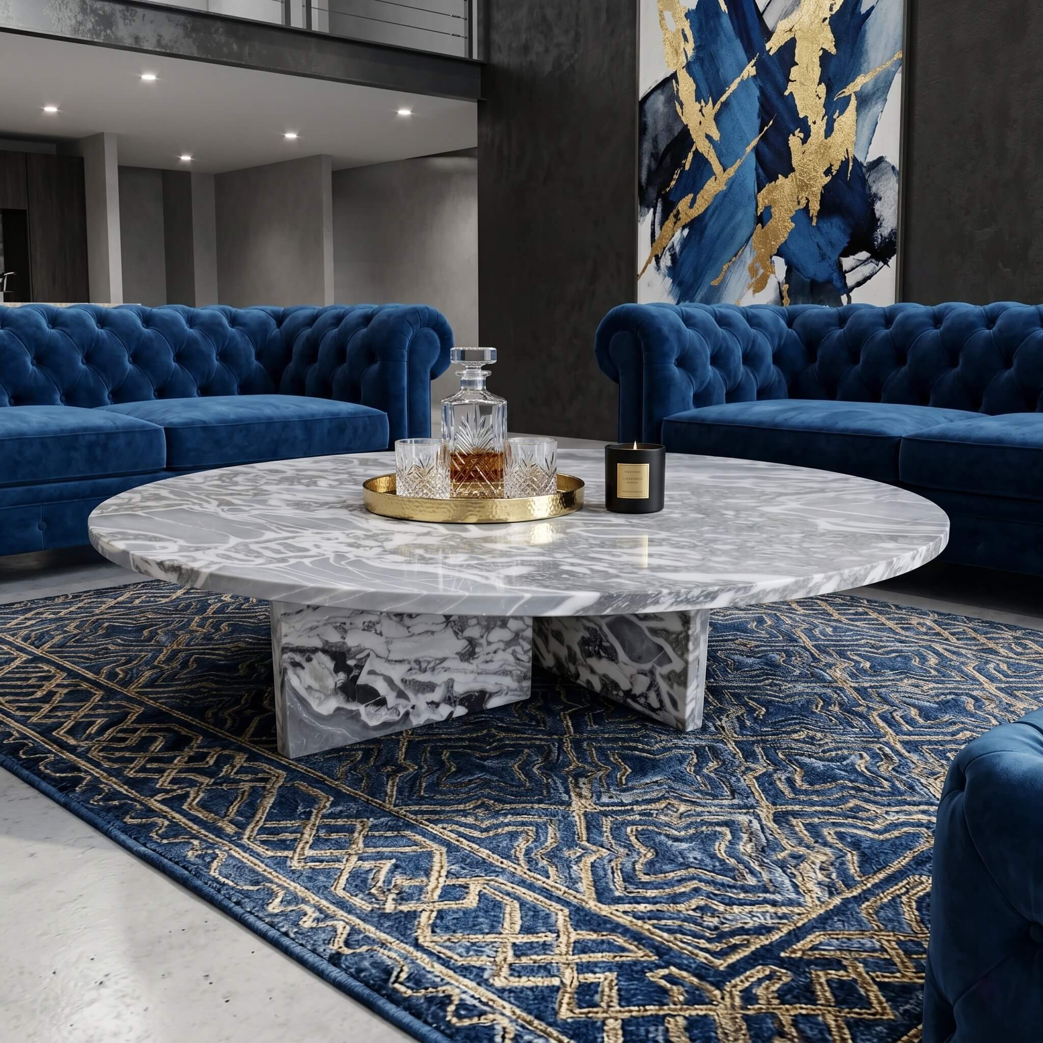Cloudy blue marble coffee table in modern glam living room with blue tufted velvet sofas and gold abstract art.