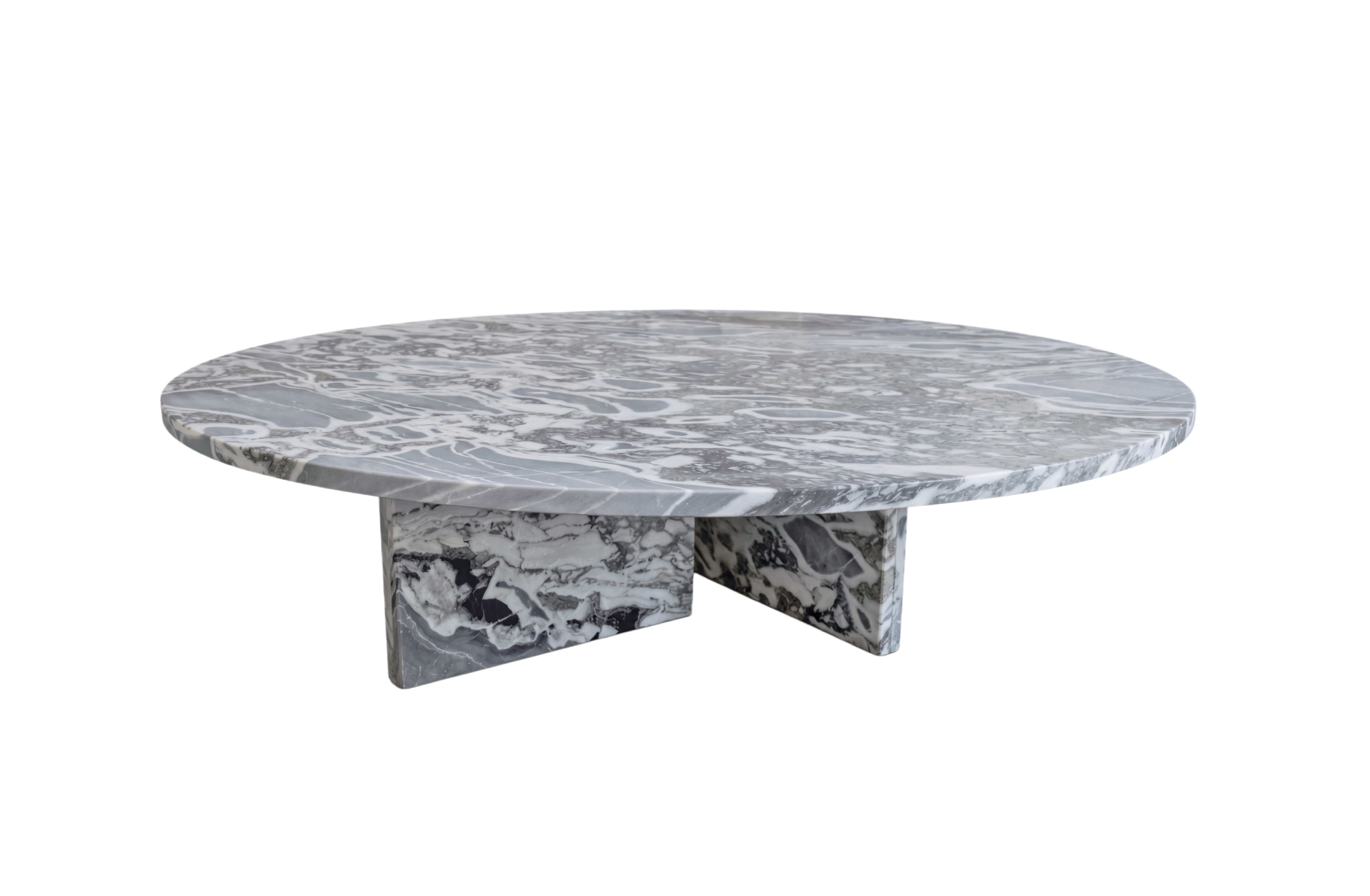 Front view of round cloudy blue marble coffee table with X-shaped marble base, showcasing dense white veining on tabletop.