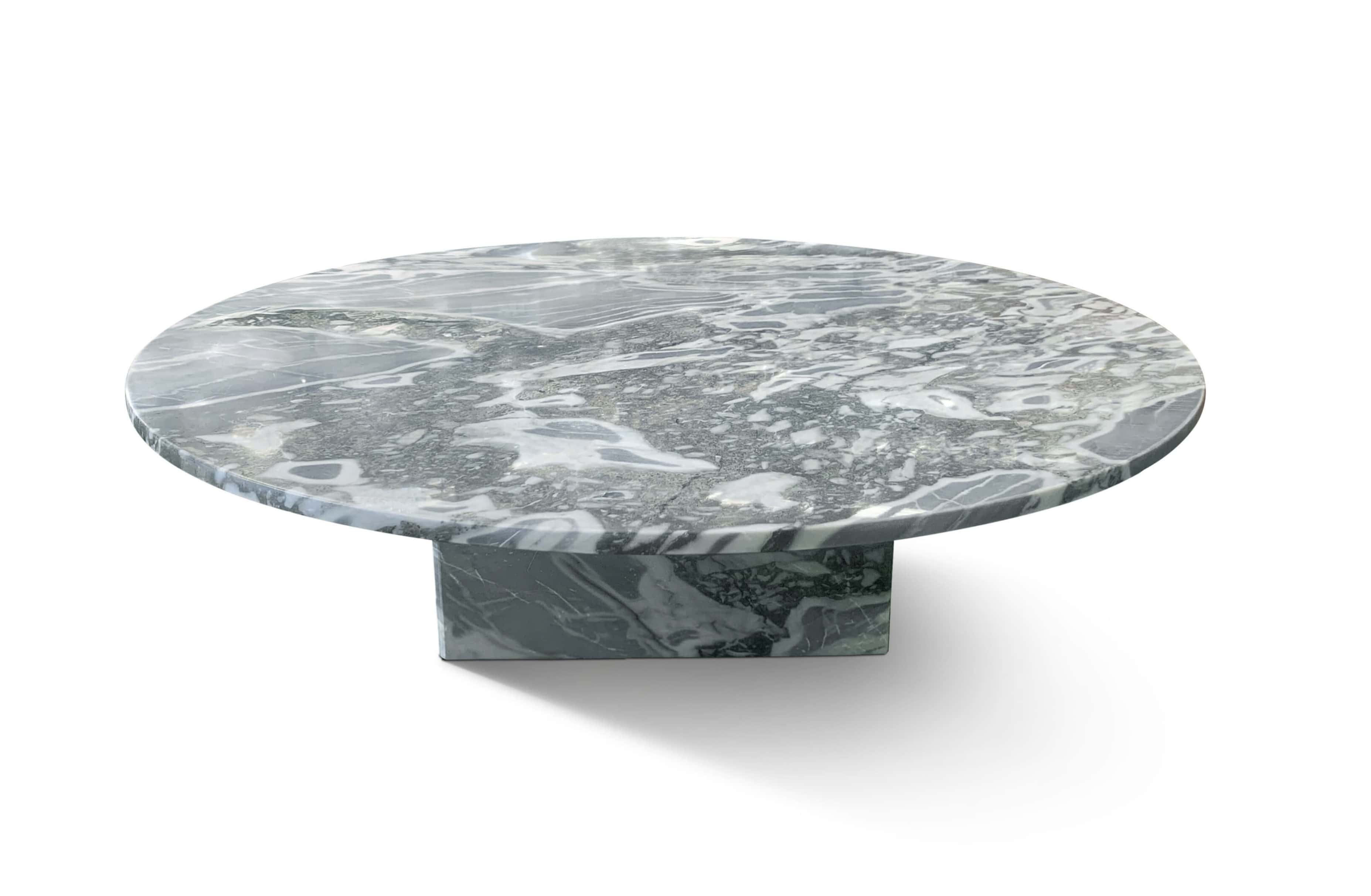 Low-angle view of cloudy blue marble coffee table showing thick polished tabletop edge and natural stone veining detail.