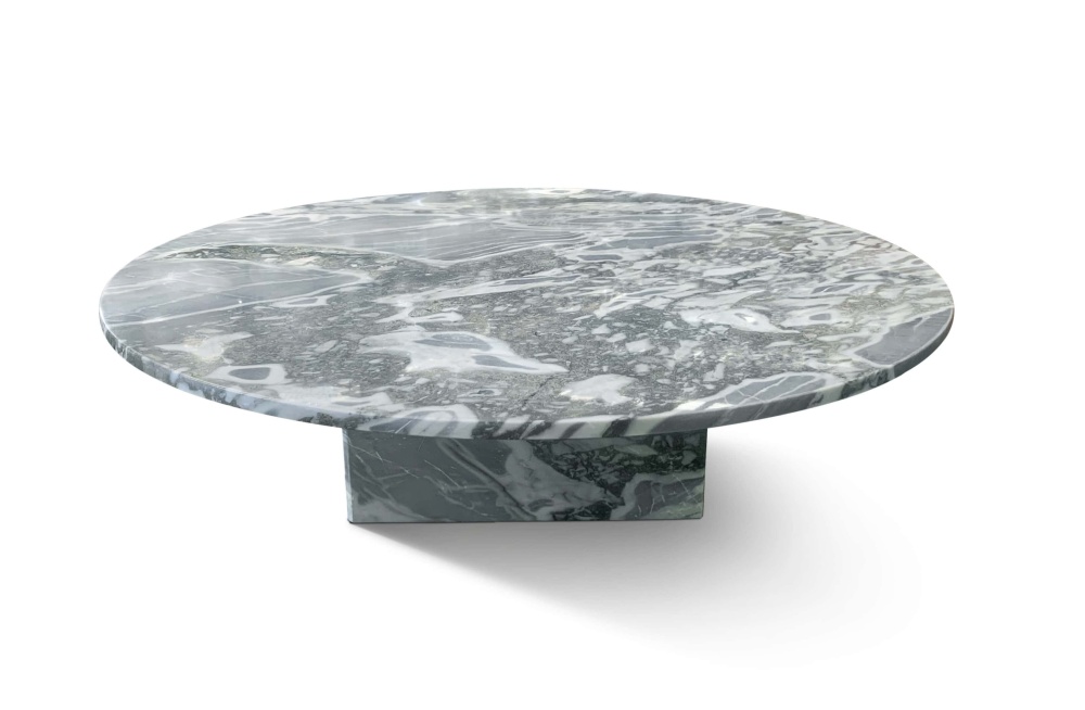 Low-angle view of cloudy blue marble coffee table showing thick polished tabletop edge and natural stone veining detail.
