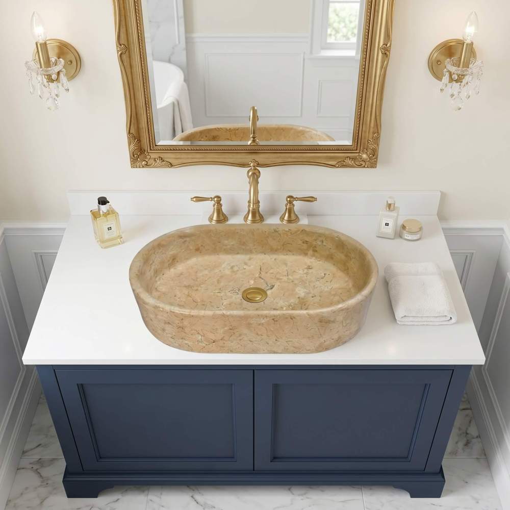 Close-up of Hyatt Gold marble vessel sink with brass three-hole faucet on white marble top, warm gold-beige veining clearly visible.