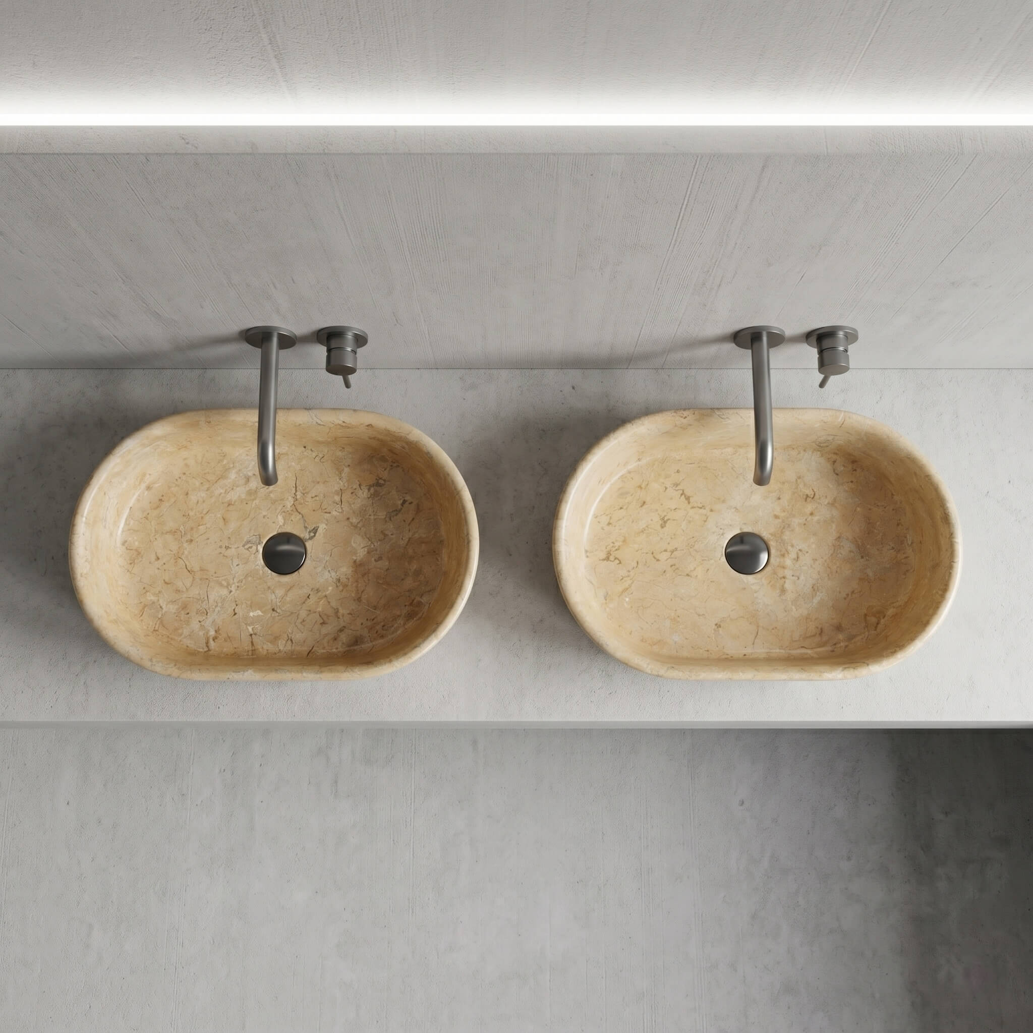 Overhead view of two Amber Gold marble vessel sinks on gray vanity, showing natural veining variation between individual units, matte faucets.
