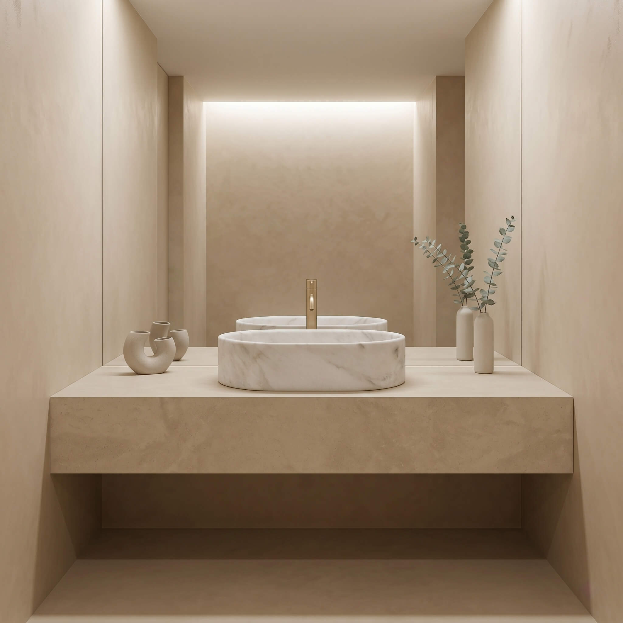 A Snow Mountain White marble oval vessel sink centered on a plaster floating ledge with champagne gold faucet and eucalyptus in a serene minimalist spa bathroom.