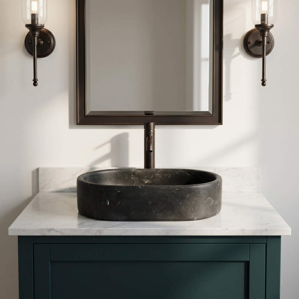 A single Olive Black marble oval vessel sink on a teal vanity with white marble top, shown front-on below a bronze mirror.