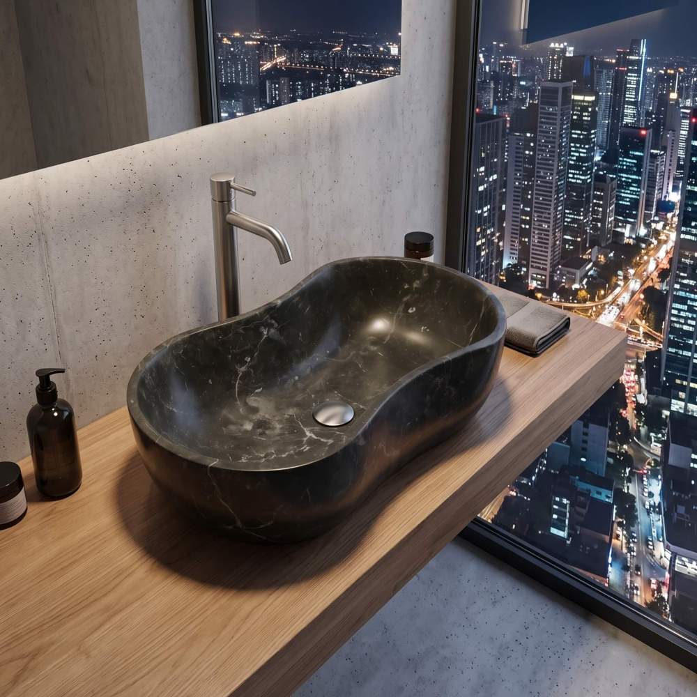 High-end penthouse bathroom displaying an Olive Black marble wave vessel sink on a floating wood vanity with an expansive city night view.