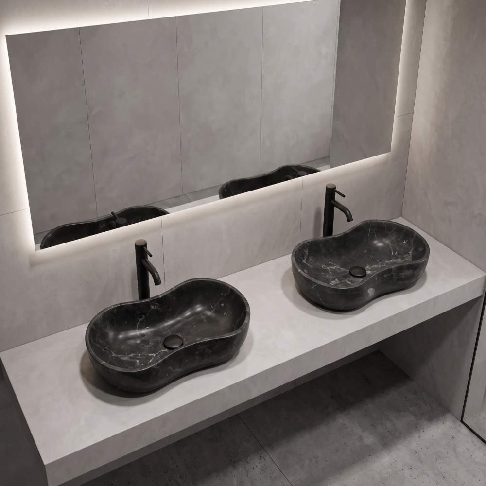 A contemporary spa-like bathroom featuring a seamless light gray concrete floating vanity supporting two dark Olive Black marble wave vessel sinks.