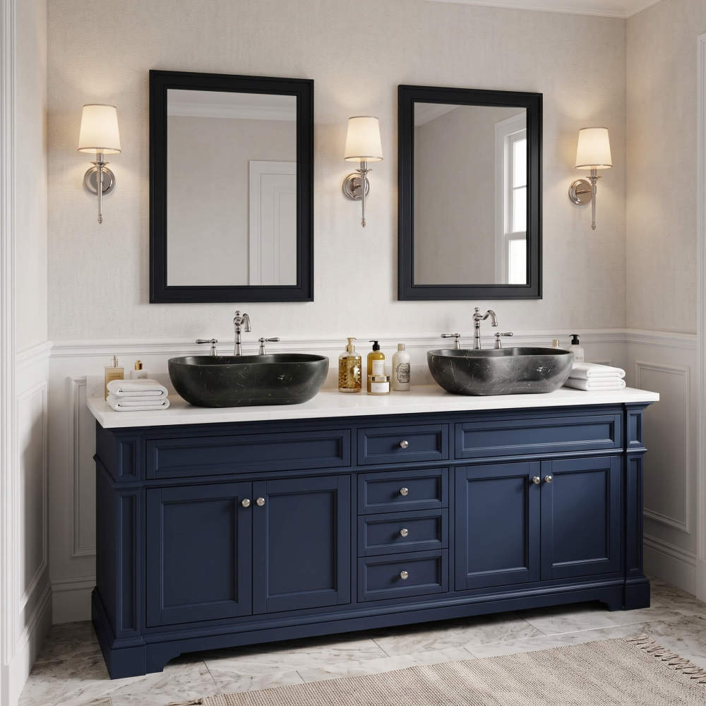 A transitional master bathroom featuring a navy blue double vanity with a white marble countertop, paired with two honed Olive Black stone basin sinks.