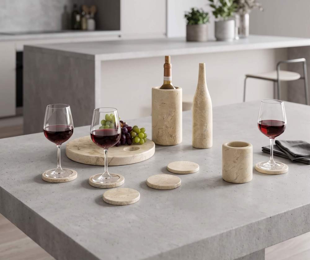 Hyatt Gold natural marble 10-piece honed set sitting on a sleek, minimalist concrete kitchen island.