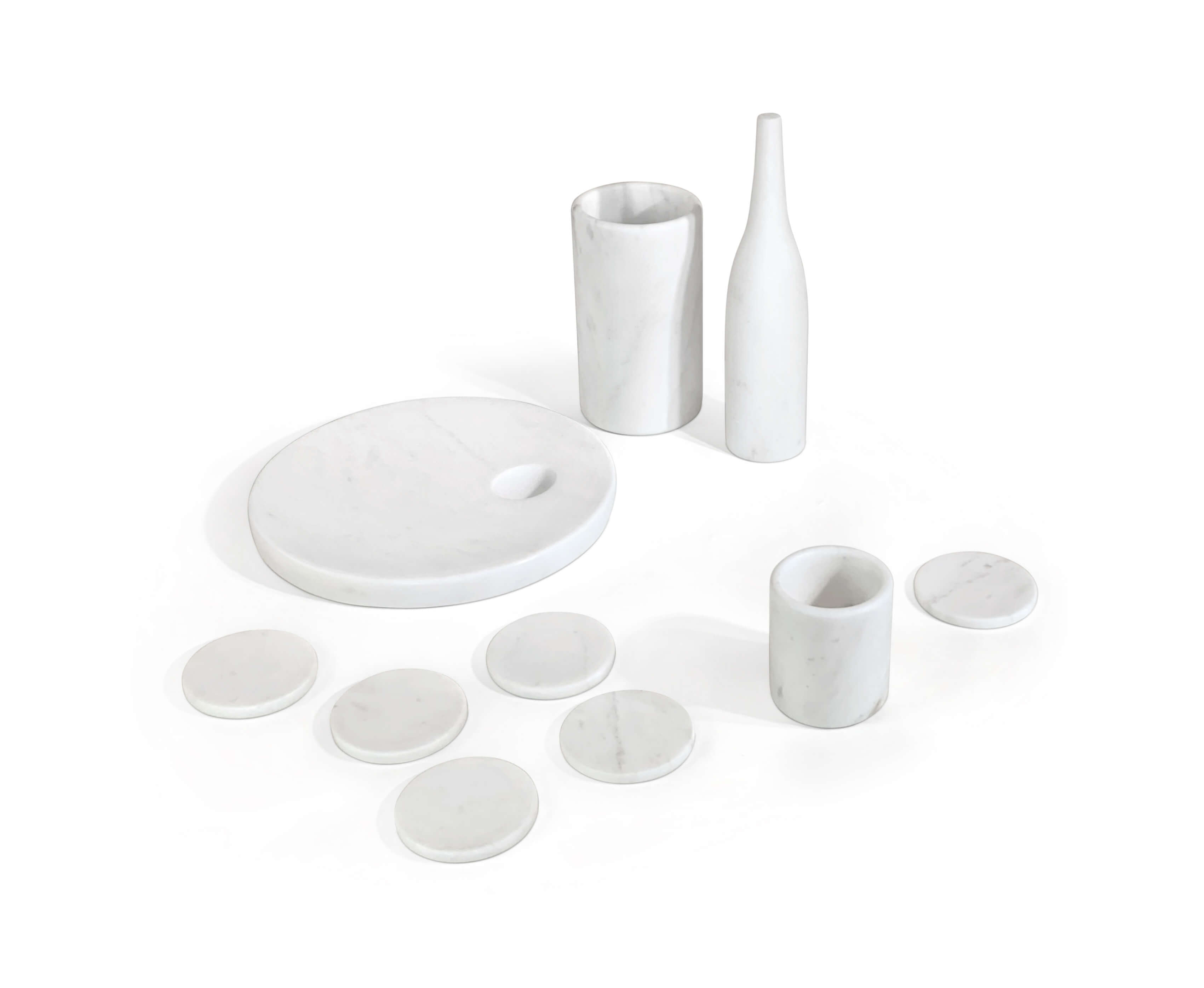 High-angle view of 10-piece Snow Mountain White honed marble home accessories set on white background.