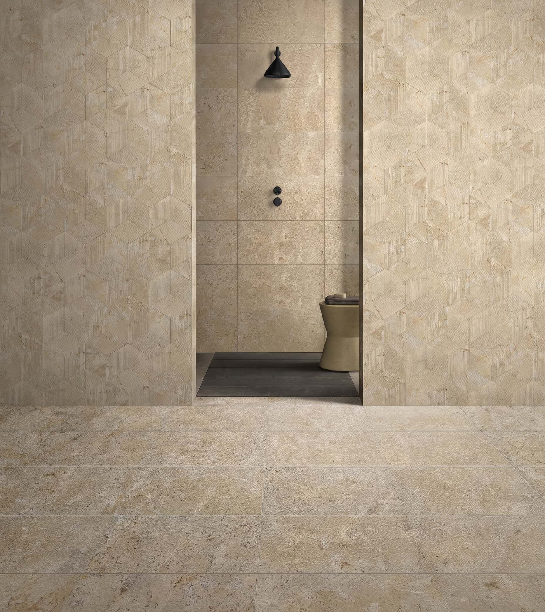 Designer bathroom featuring 12x24 Amber Gold leathered marble floor paired with Hexagon FS textured wall tiles.