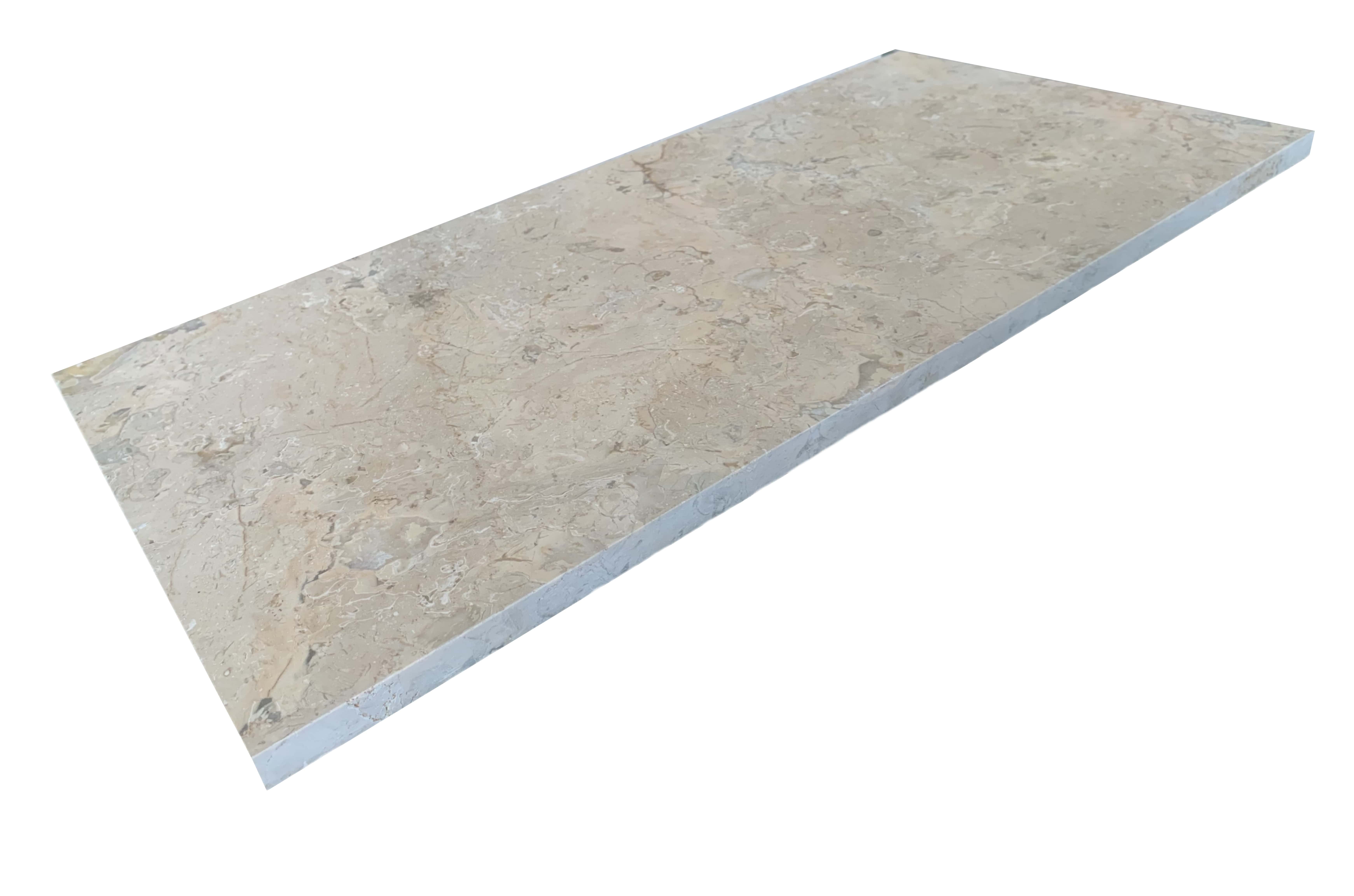 Oblique view of a single 12x24 inch Amber Gold honed marble tile, highlighting its surface texture and edge thickness.