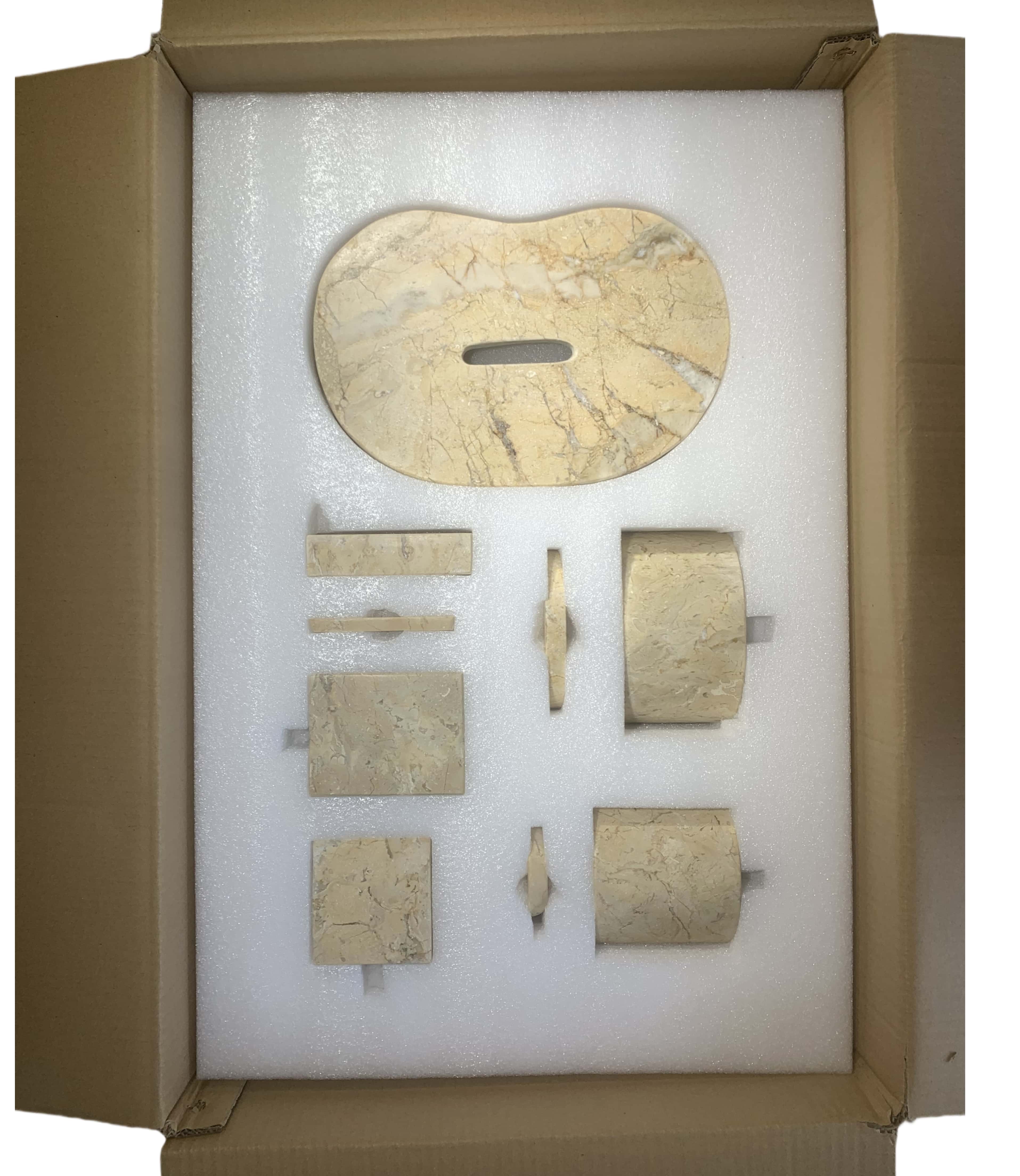 Top view of damage-proof shipping box with custom molded foam insert protecting all gold marble set pieces.