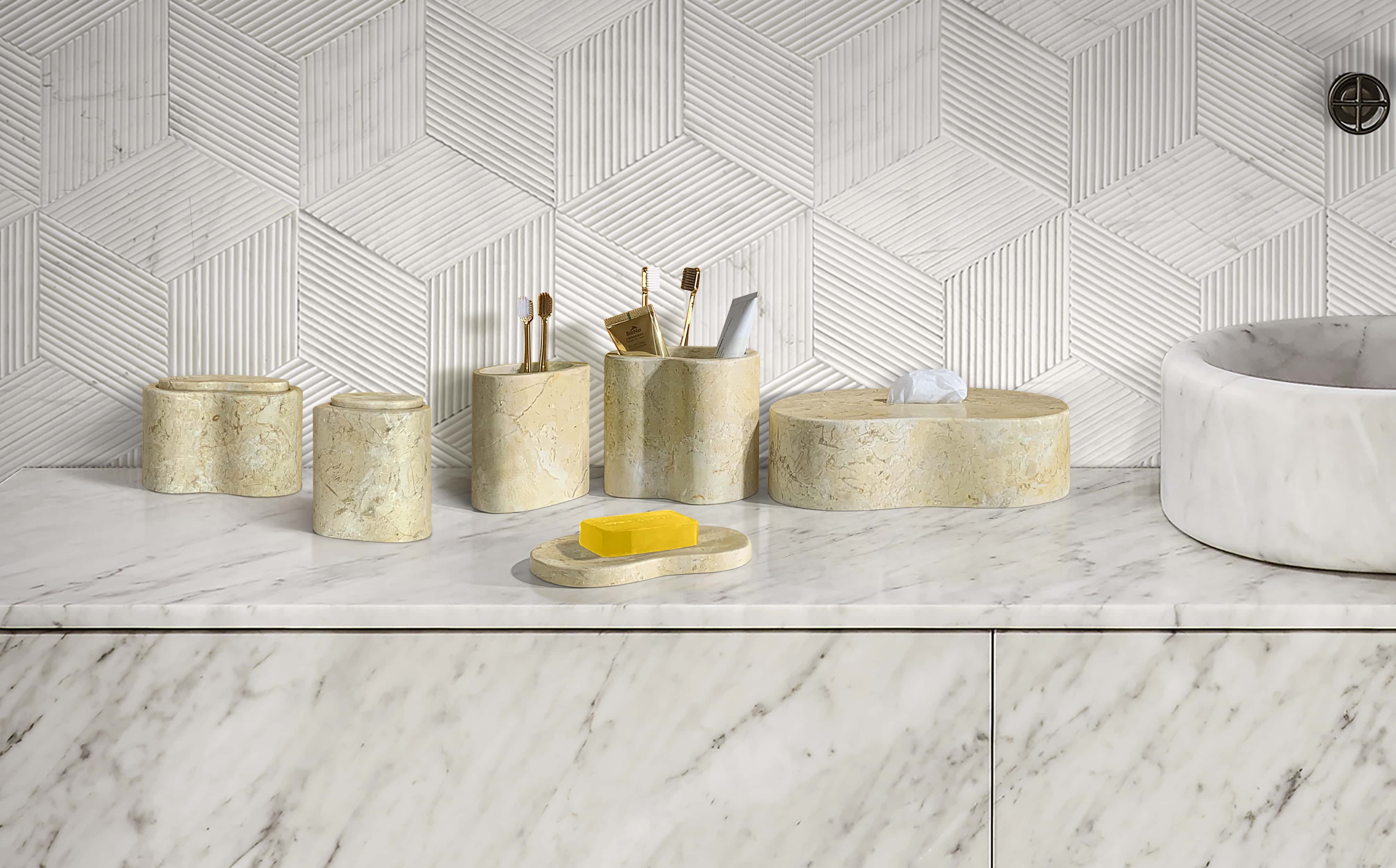 Organic wave-style amber gold natural marble 6-piece bathroom vanity accessory set arranged on marble counter.