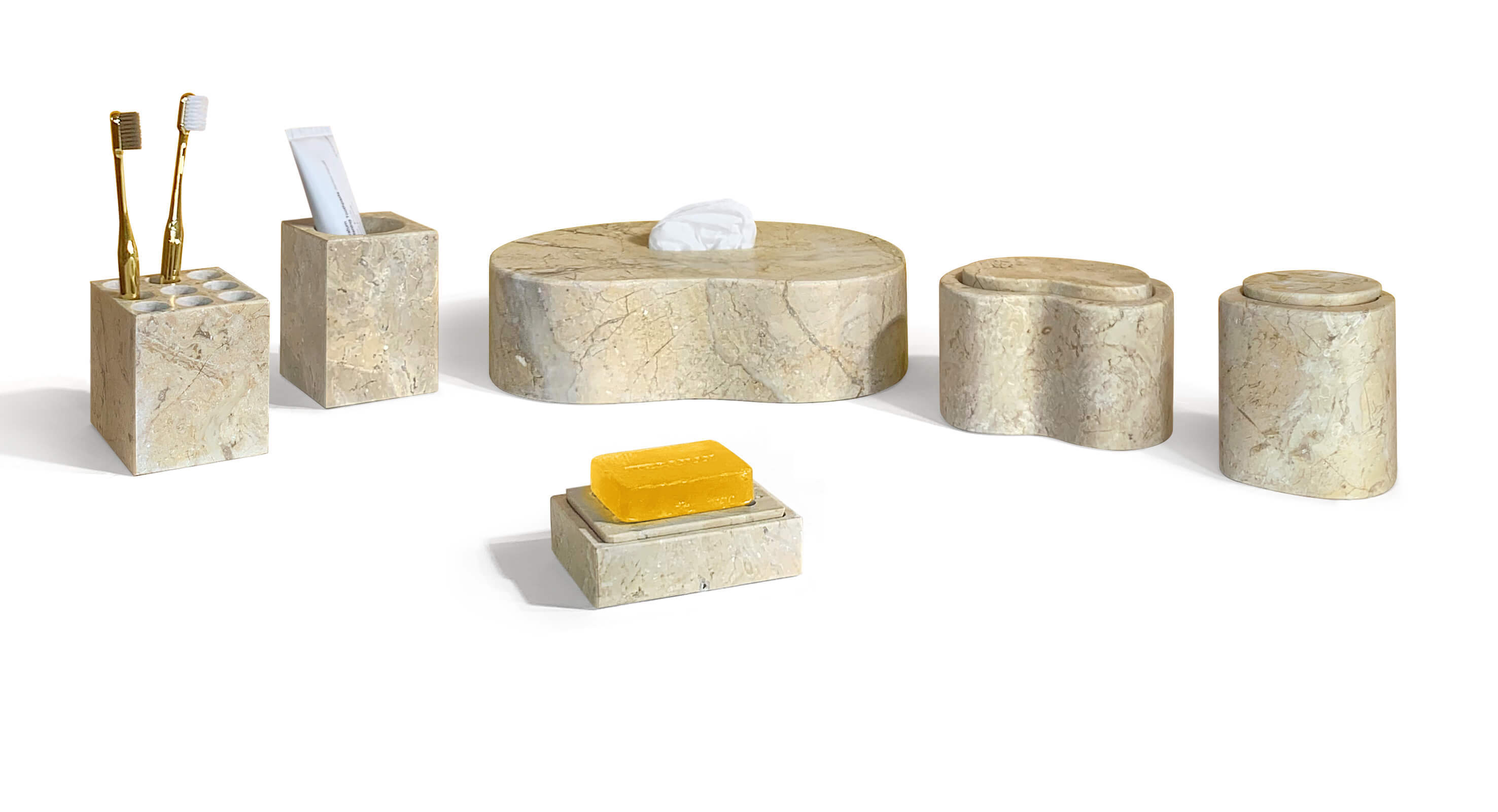 Styled 6-piece gold marble vanity set filled with toothbrushes, toothpaste, tissue, and bar soap on white.