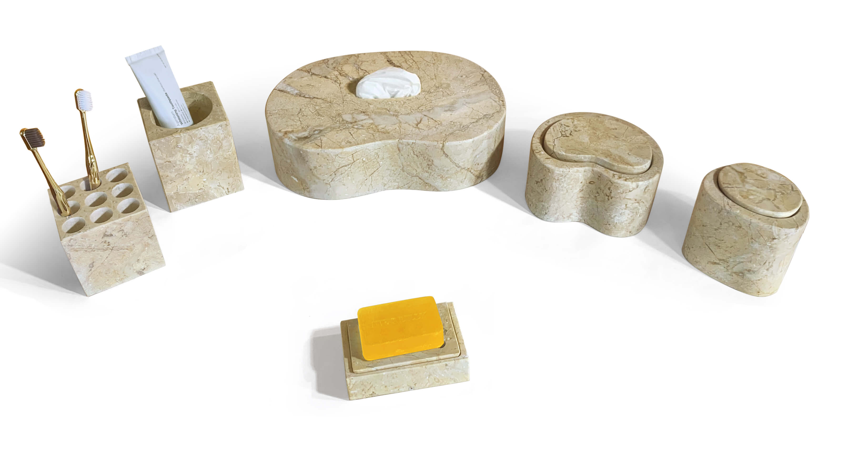 High-angle view of styled amber gold marble vanity accessories with toothbrush, soap, and tissue inserted.