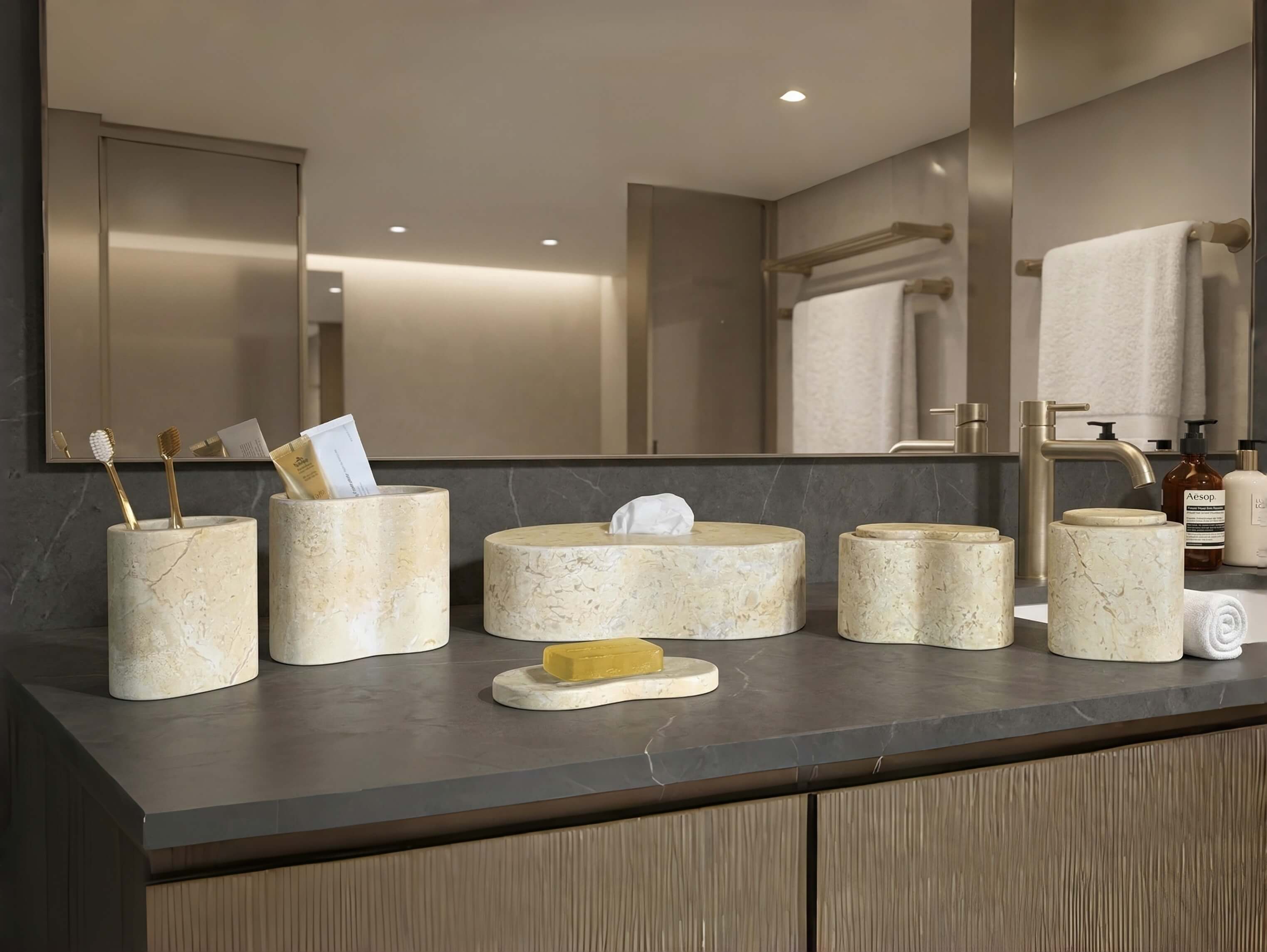 Amber Gold Wave natural marble 6-piece vanity accessory set styled on a sleek dark gray countertop in a luxury bathroom.