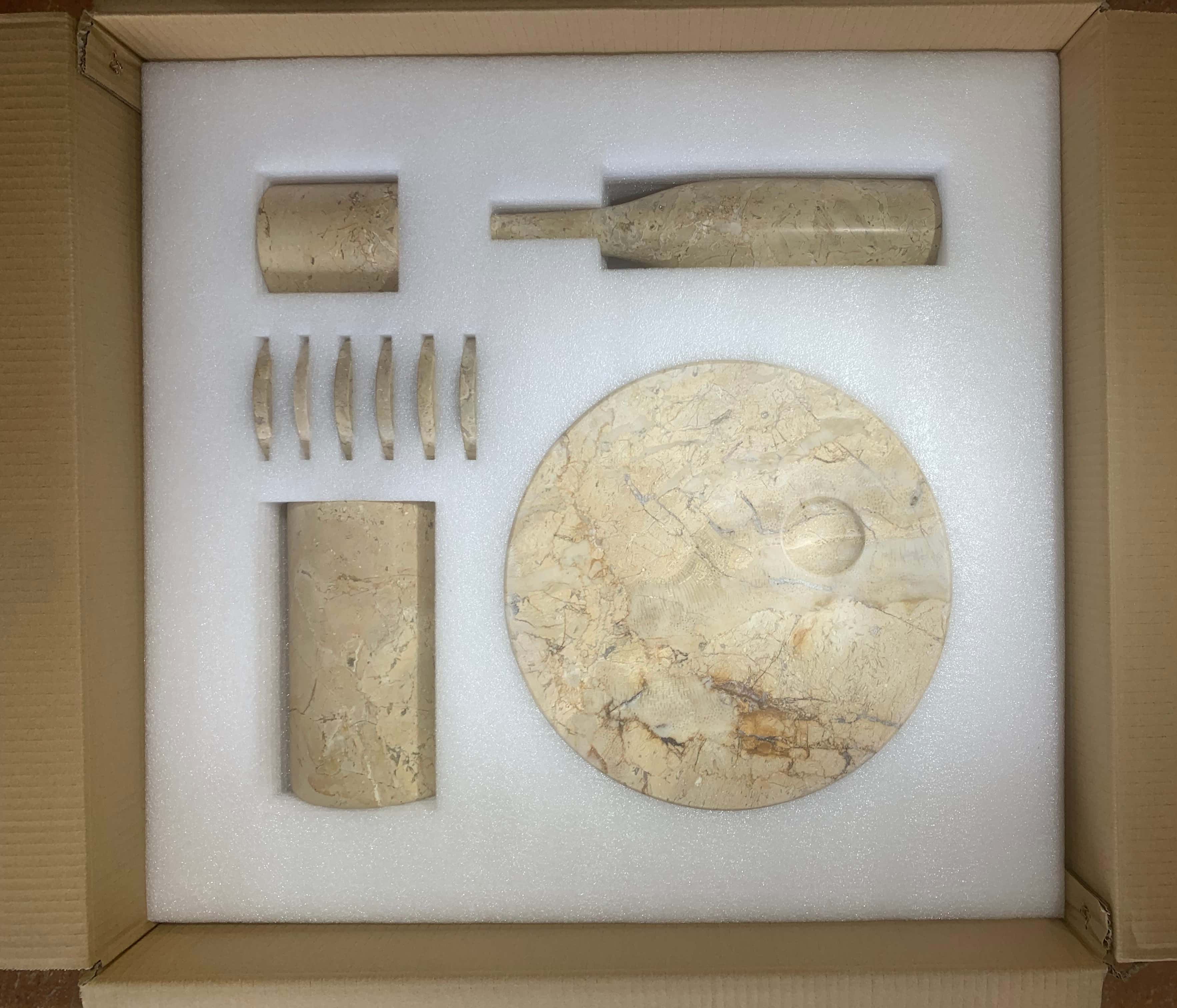Custom shock-absorbing foam packaging vault securing all 10 individual Amber Gold natural marble pieces during shipping.