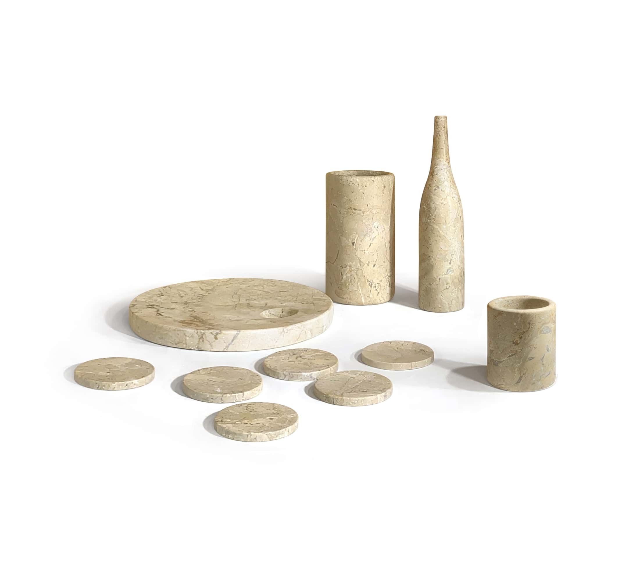 Complete 10-piece Amber Gold natural marble dining accessories set shown at a perspective angle with honed finish.