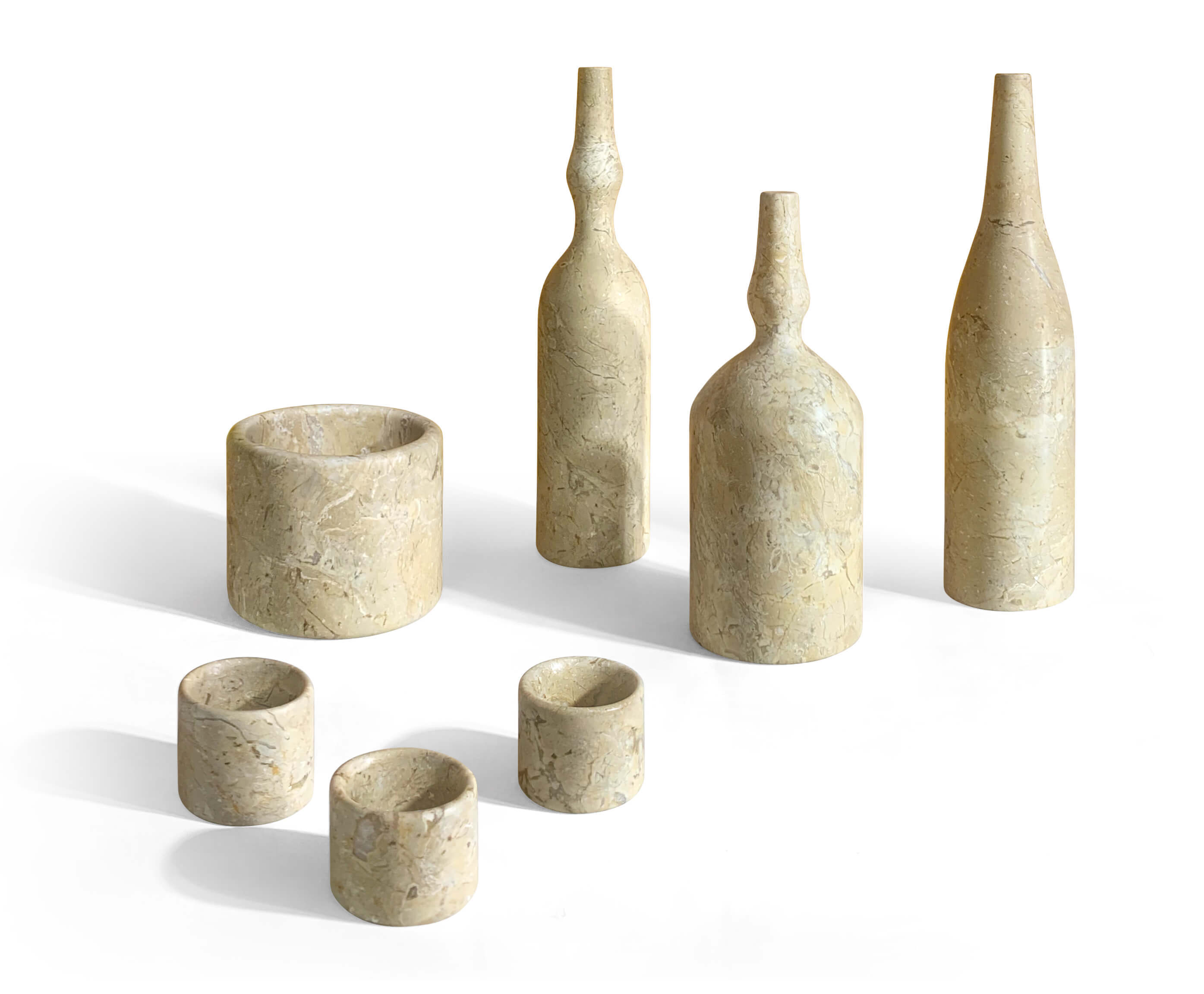 Seven-piece Amber Gold natural marble living decor set featuring three vases, three tealight holders, and a diffuser base.