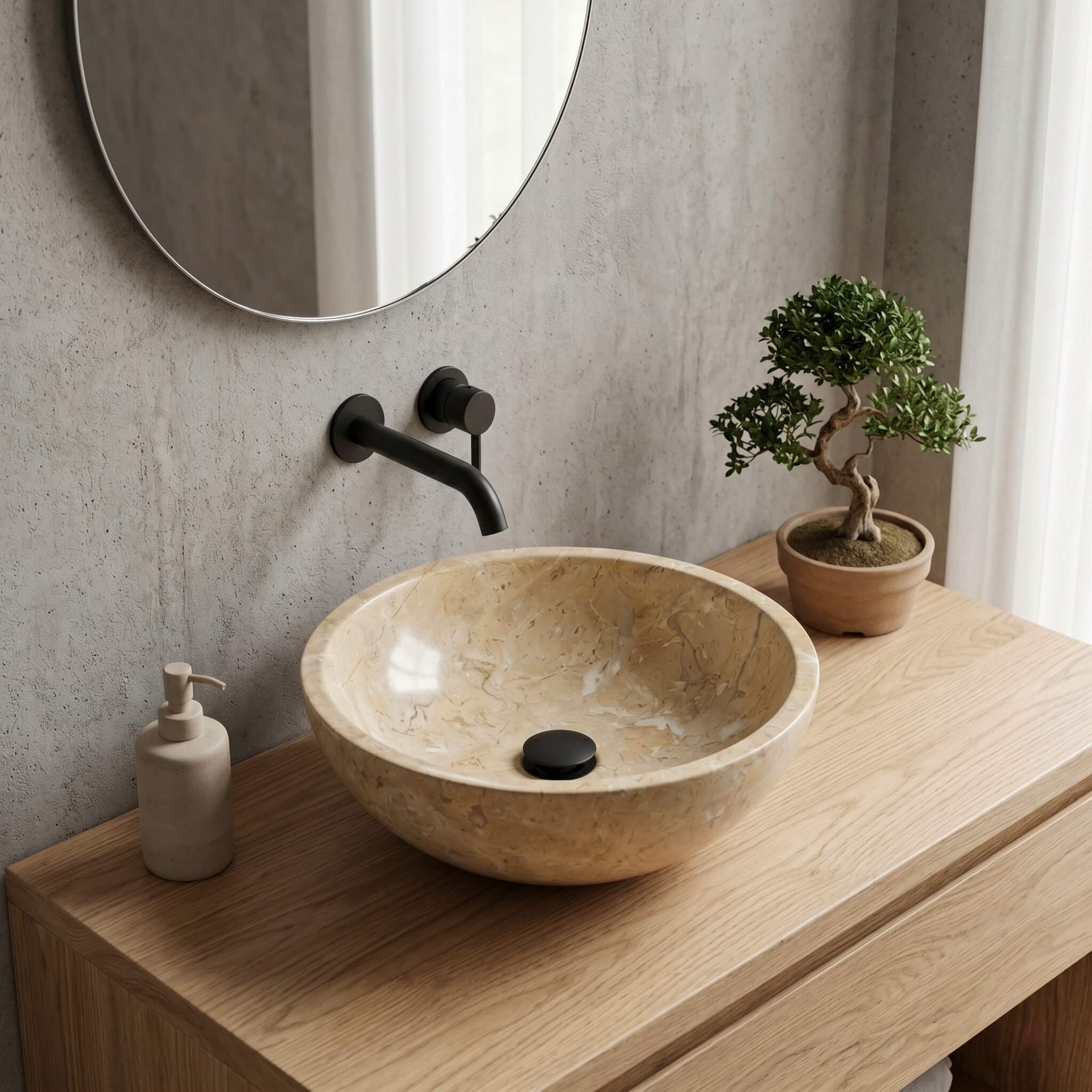 Amber Gold round marble vessel sink on light oak floating vanity with black faucet, Japandi-style bathroom with bonsai accent.