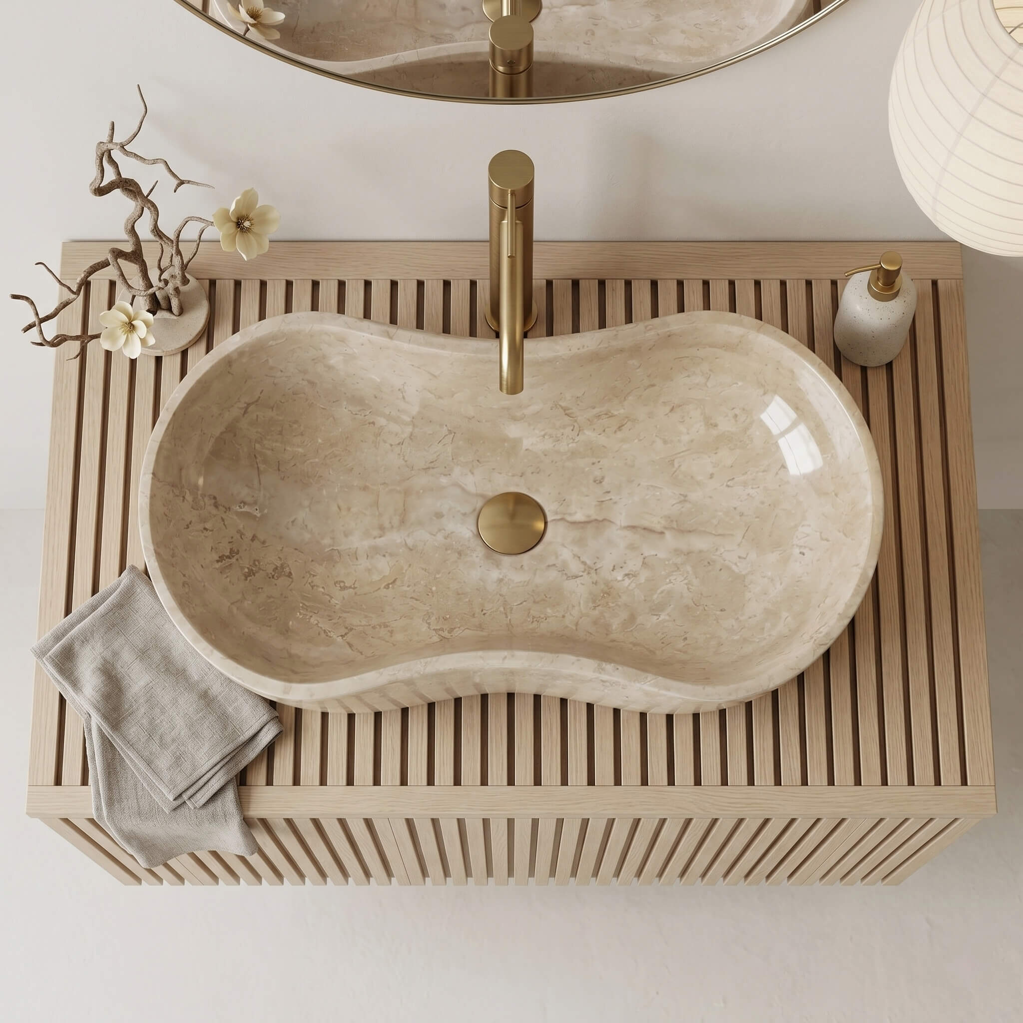 Top-down view of an Amber Gold marble Wave vessel sink on a slatted oak vanity, serene Japandi bathroom.