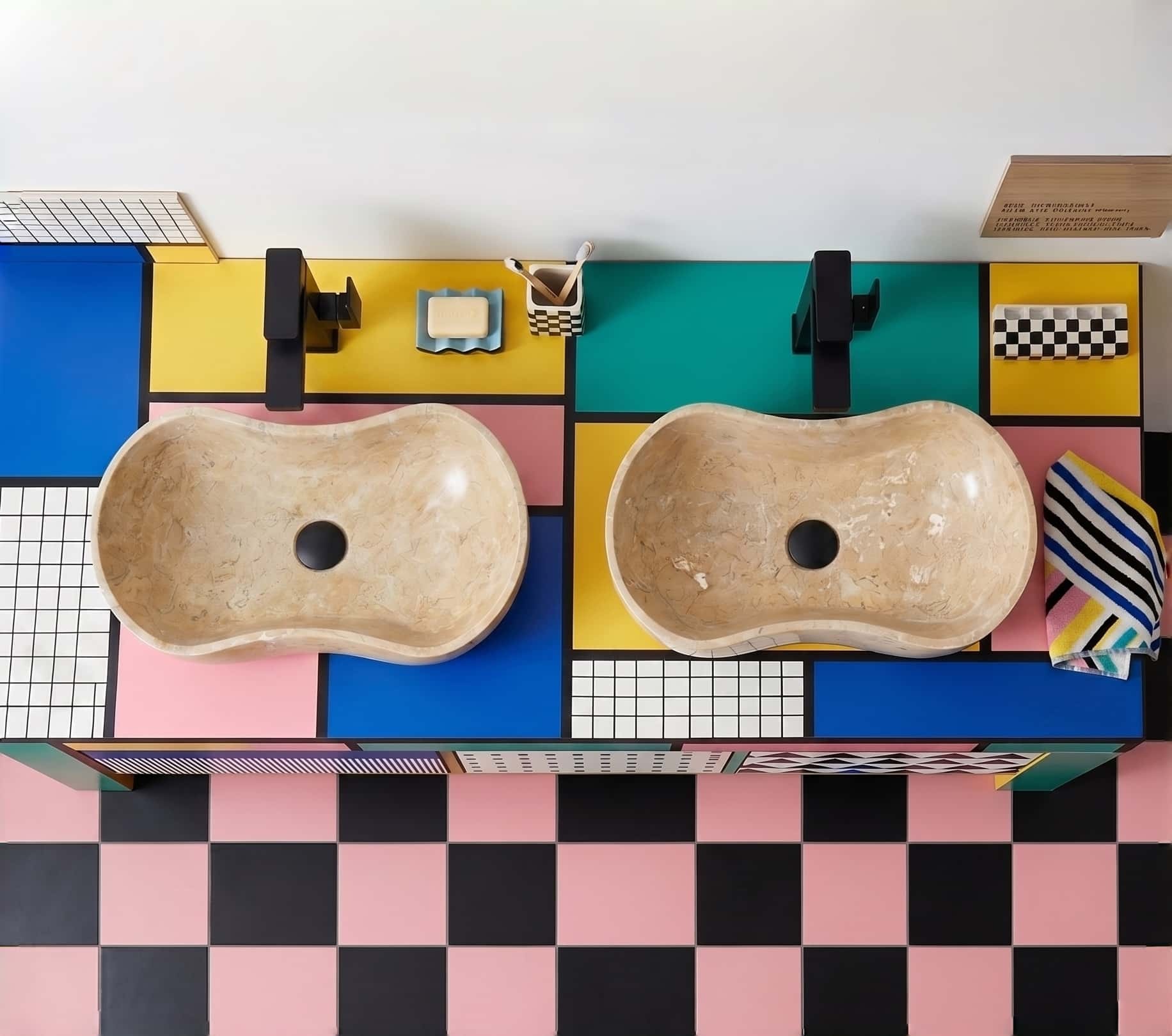 Top-down view of two Amber Gold marble Wave vessel sinks on a color-block Memphis counter, playful bathroom.
