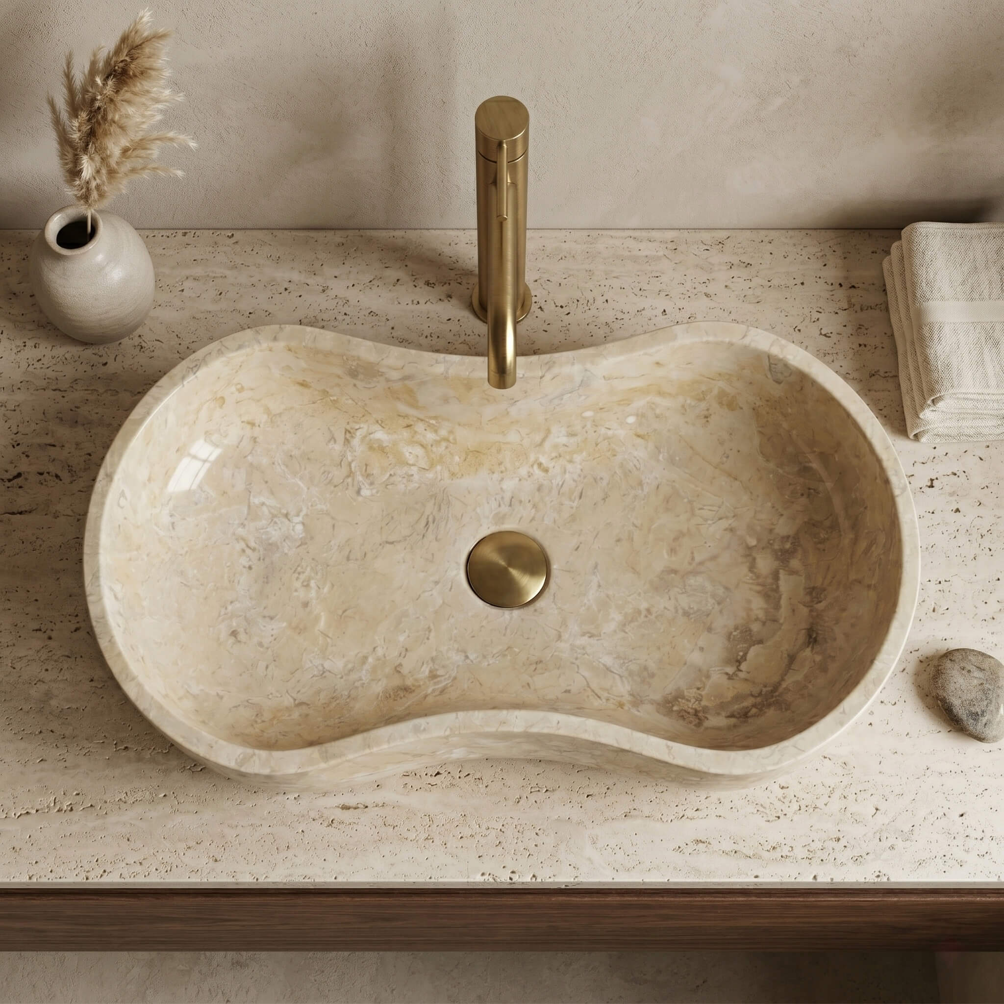 Top-down view of an Amber Gold marble Wave vessel sink on a travertine counter, calm Wabi-Sabi bathroom.
