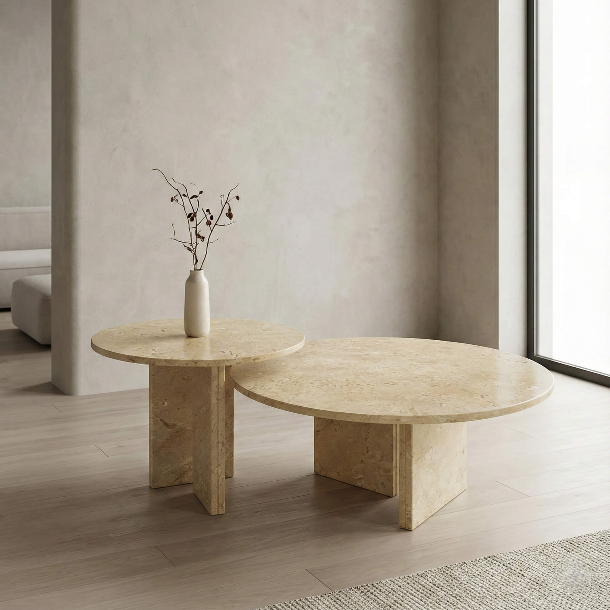 Amber Gold natural marble nesting coffee tables in a Wabi-Sabi interior with plaster walls and natural light.