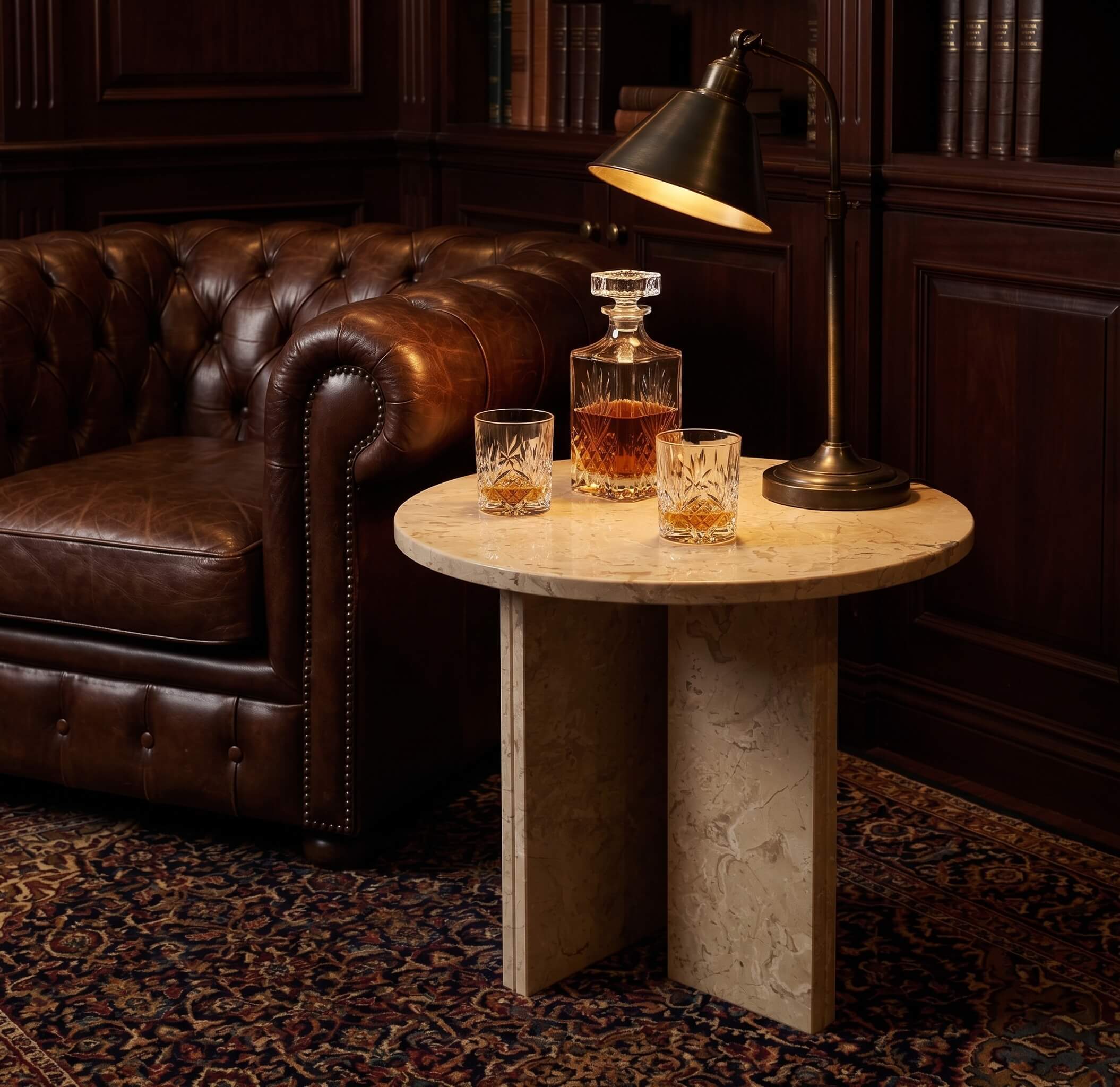 Amber Gold 45cm marble accent table styled with a whiskey decanter beside a leather armchair in a moody lounge.