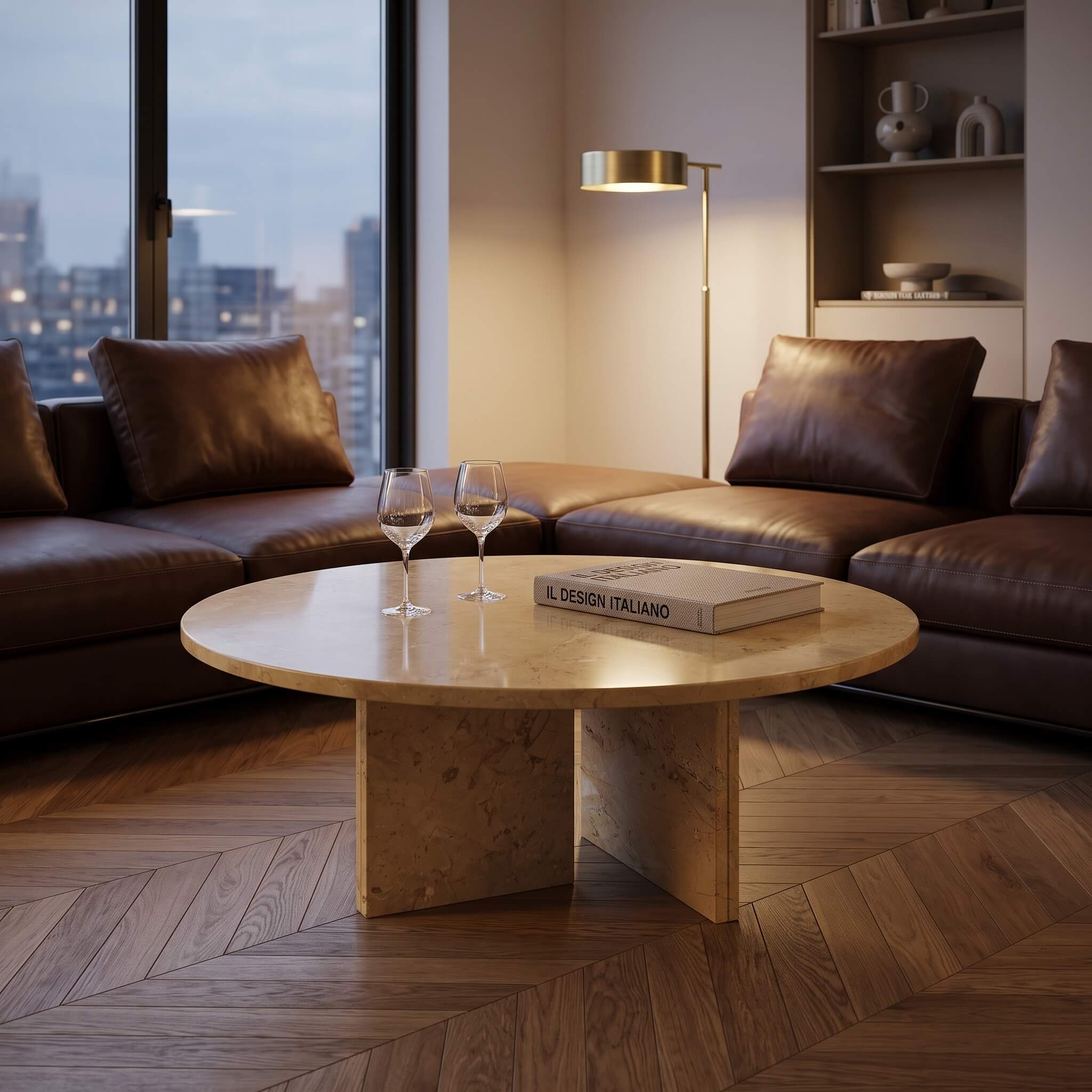 Moody evening apartment lounge with Amber Gold natural marble round coffee table set before brown leather sectional.